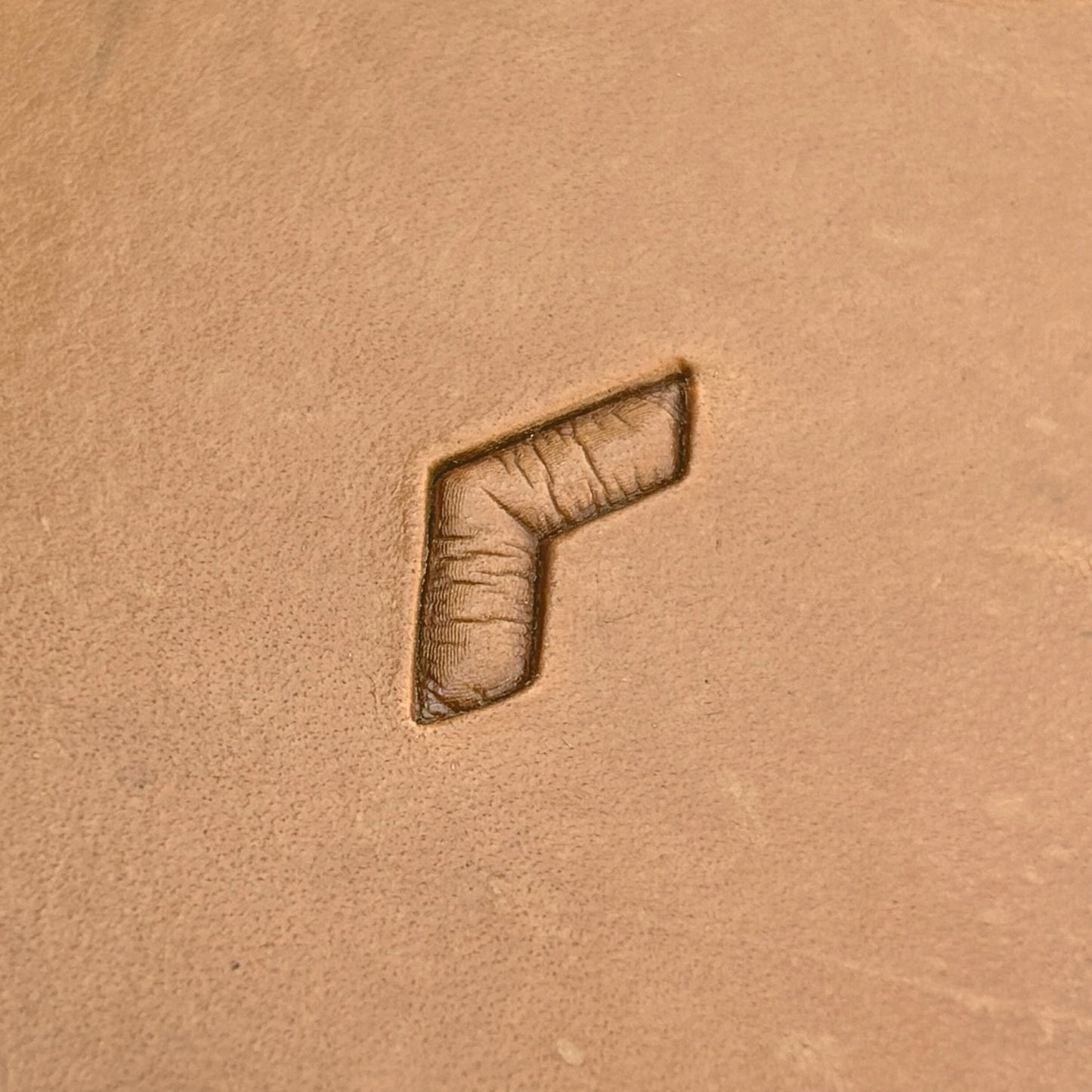 Geometric leather stamp LT037 — single impression on veg-tan leather