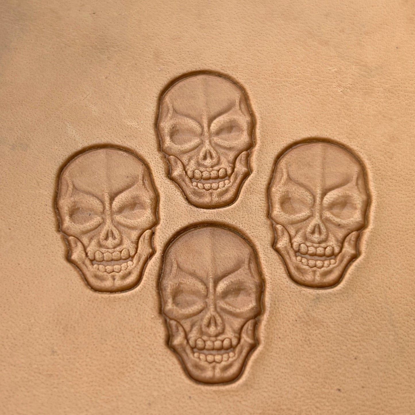 Grim Face Skull leather stamp LT080 — single impression on veg-tan leather
