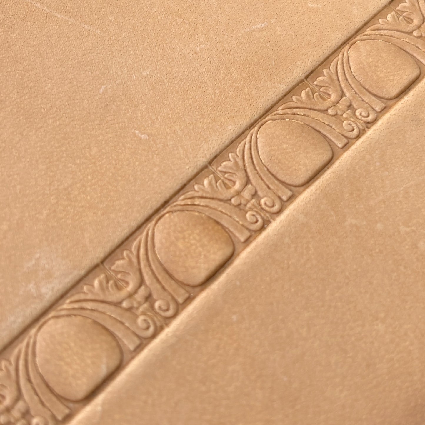 Art Deco leather stamp LT150 — single impression on veg-tan leather