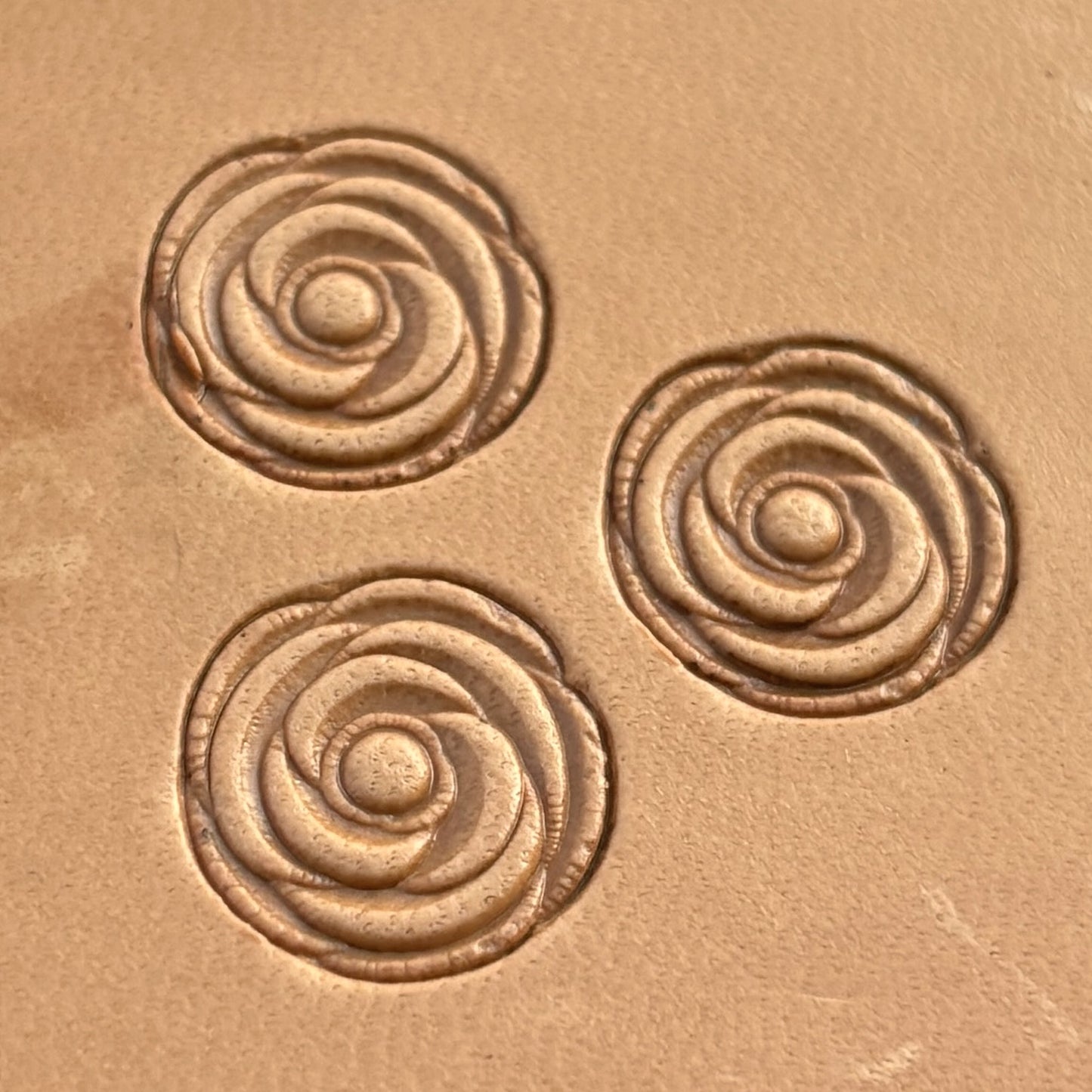 Rose leather stamp LT165 — single impression on veg-tan leather