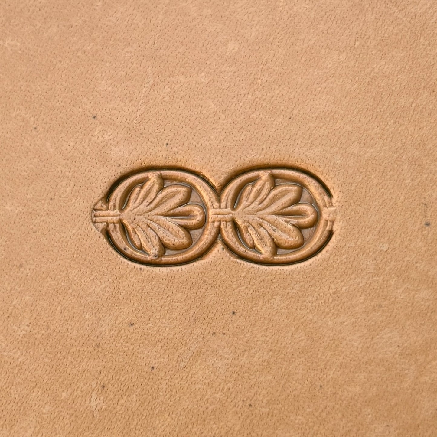 Double Oval 1 Leaf leather stamp LT170 — single impression on veg-tan leather