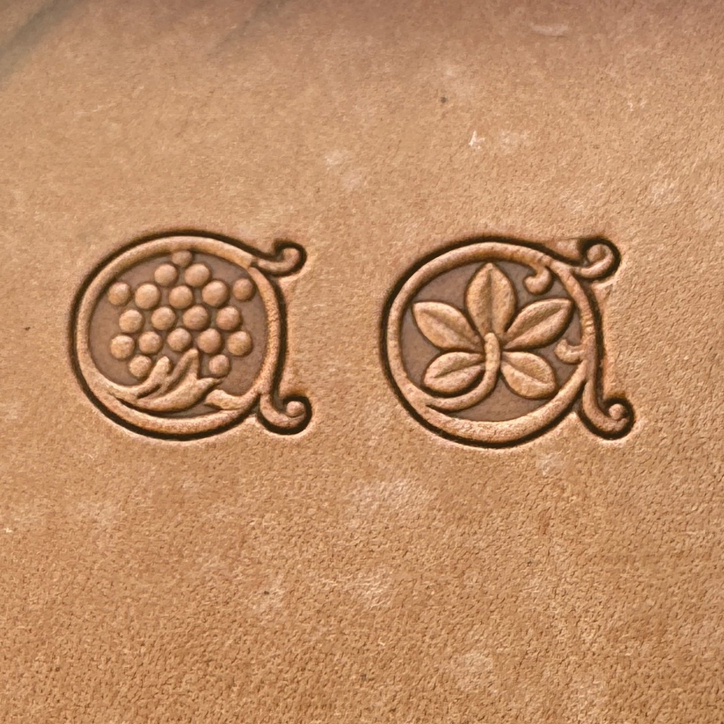 Grape Vine leather stamp LT184AB — single impressions of the grape cluster and vine leaf stamps on veg-tan leather