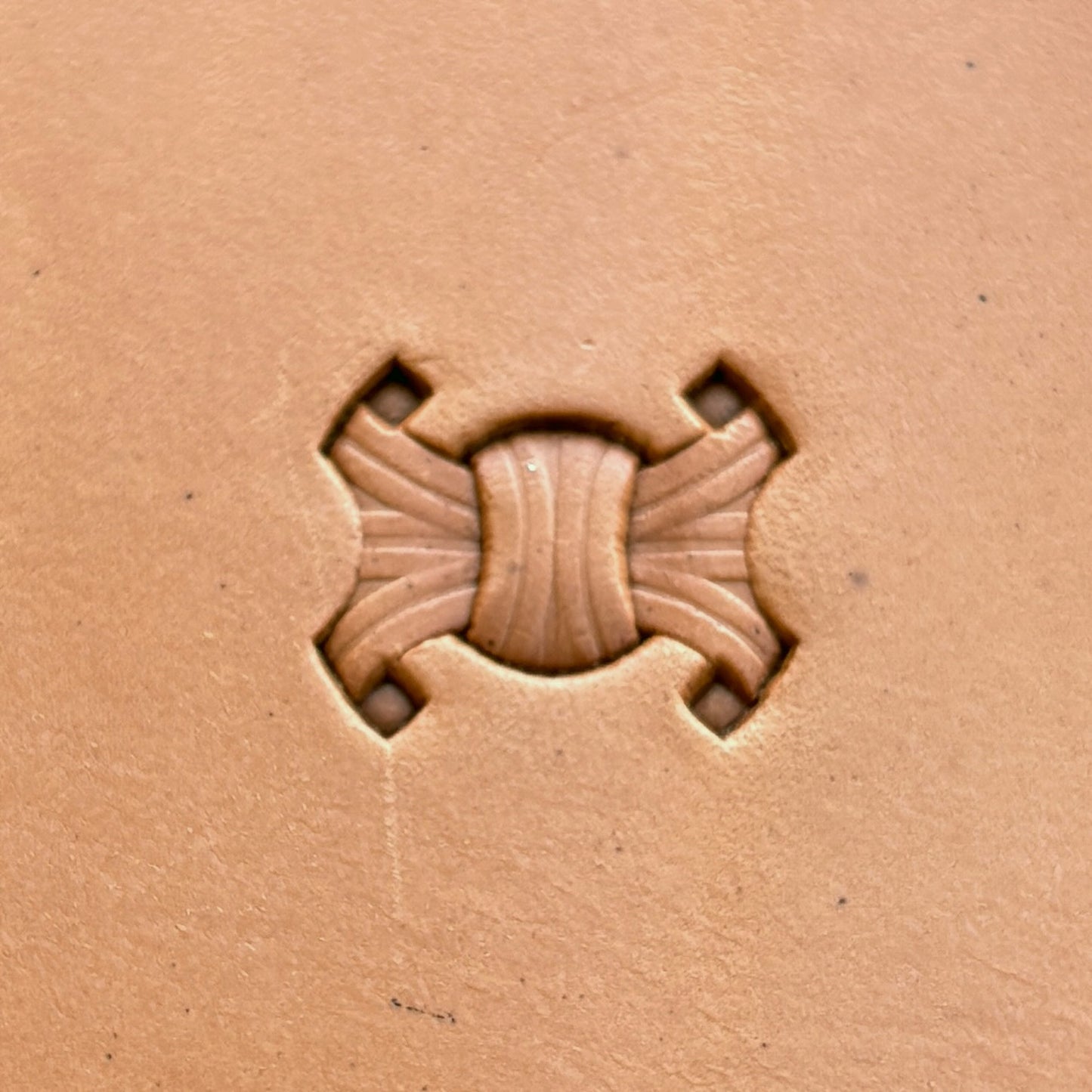 Interlocking Design leather stamp LT229 — single impression on veg-tan leather