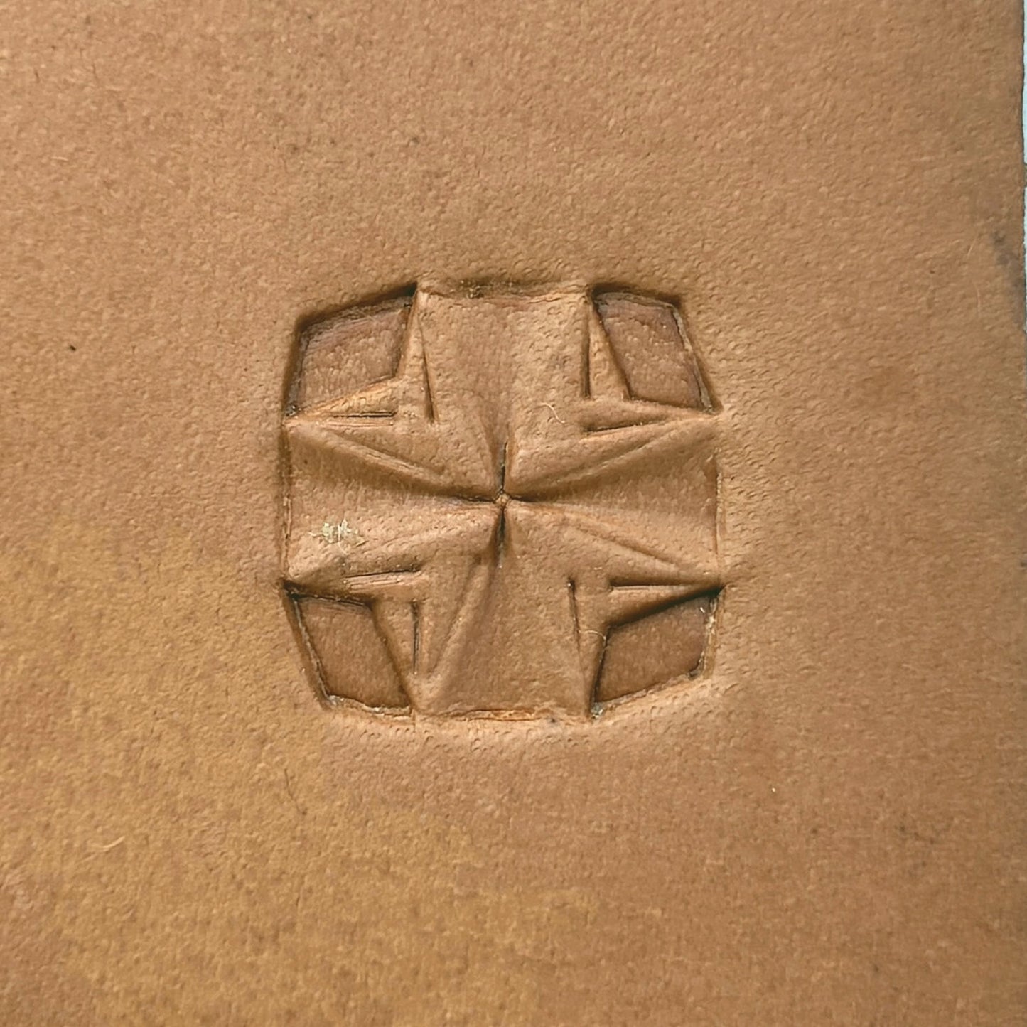 Folded Star Geometric leather stamp LT307 — single impression on veg-tan leather