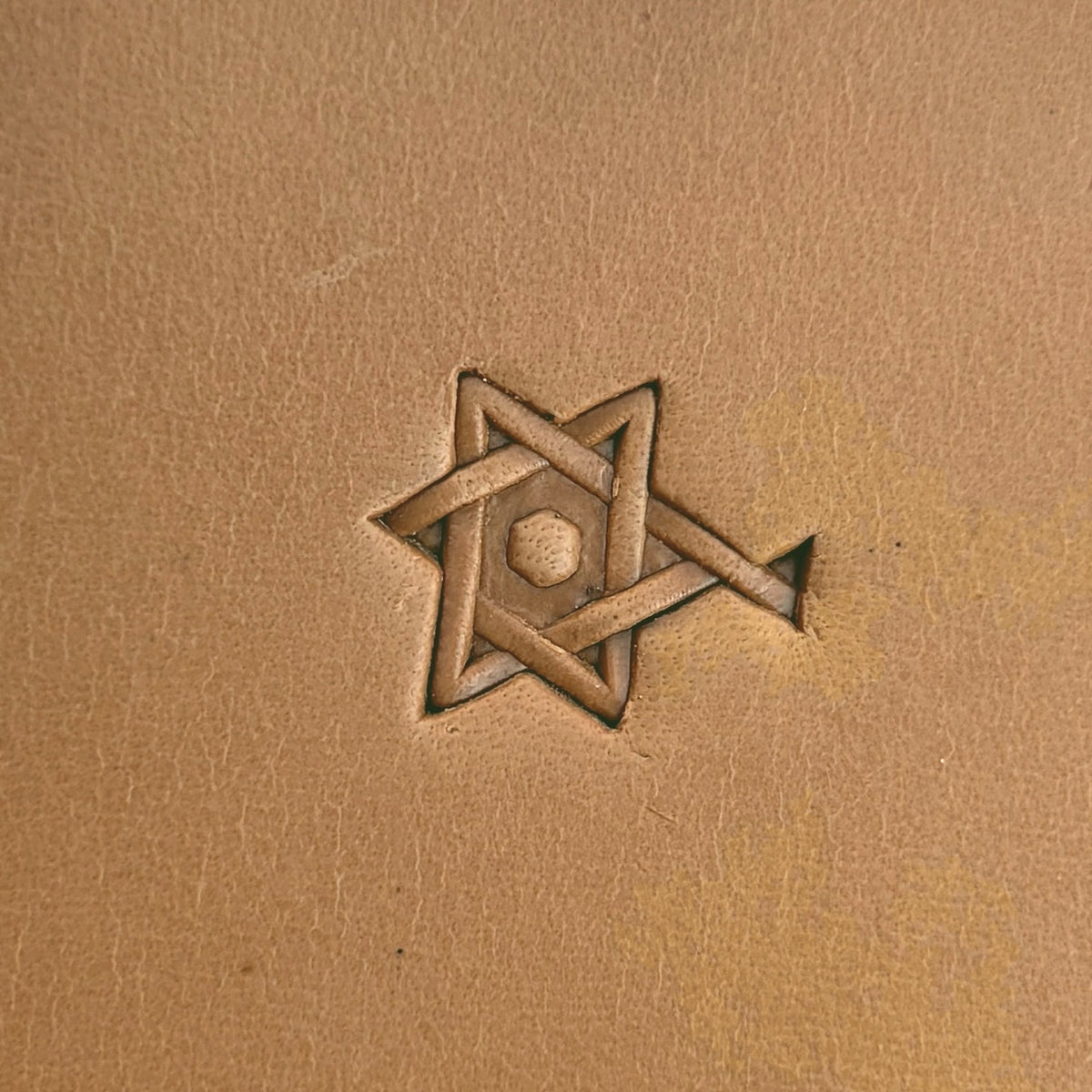 Interlocking Stars Geometric leather stamp LT516 — single impression on veg-tan leather