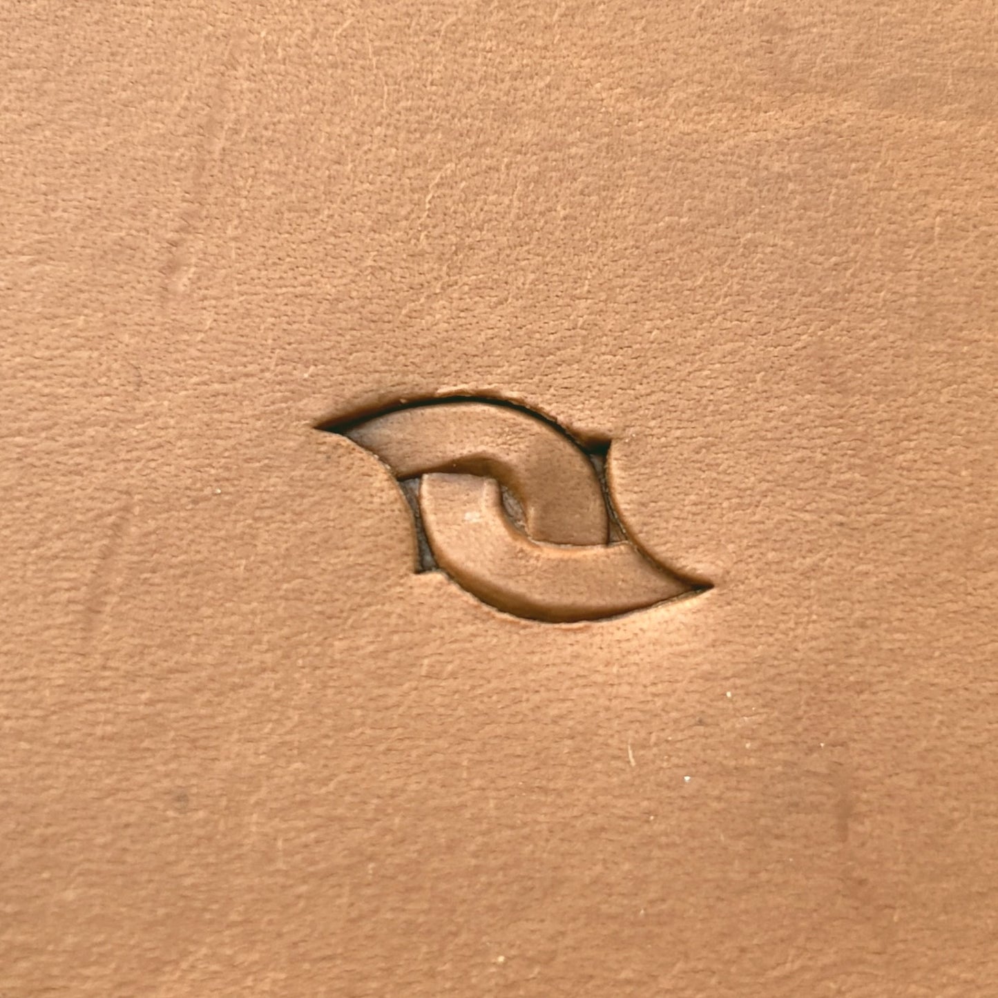 Interlocking Loop leather stamp LT601 — single impression on veg-tan leather