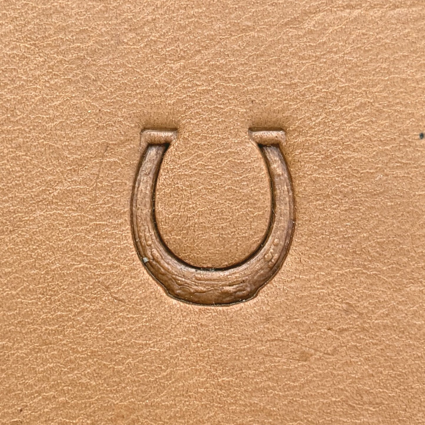 Horseshoe leather stamp LT614 — single impression on veg-tan leather