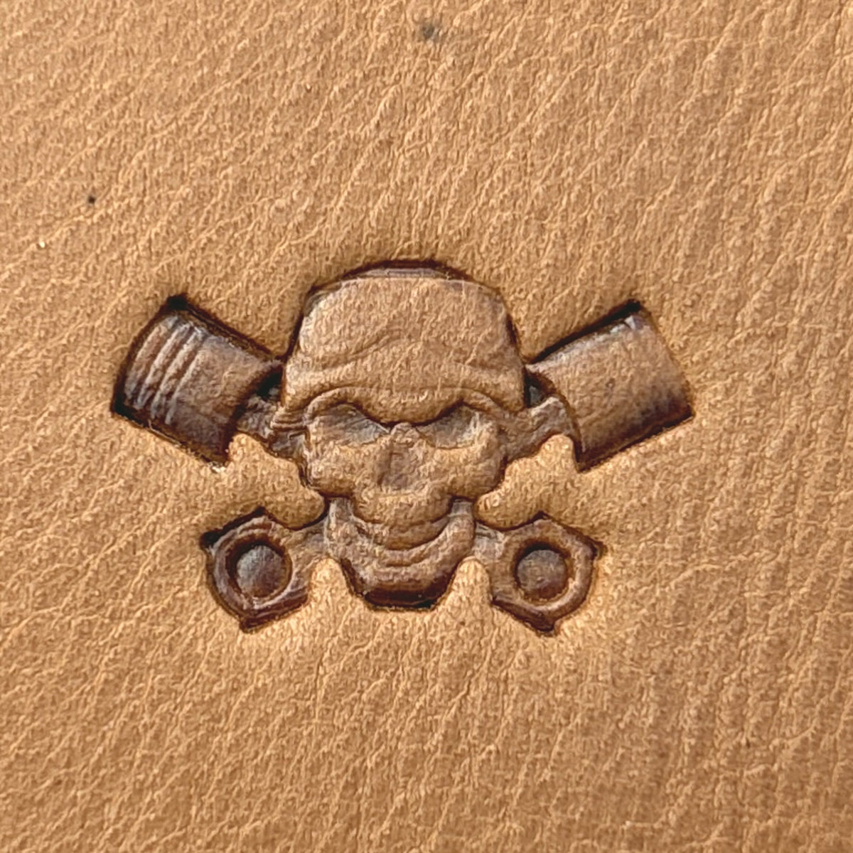 Piston Crossbones Skull leather stamp LT692 — single impression on veg-tan leather