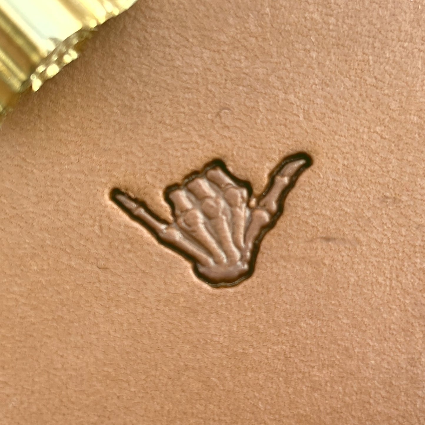 Shaka Hand Skull leather stamp LT719 — single impression on veg-tan leather