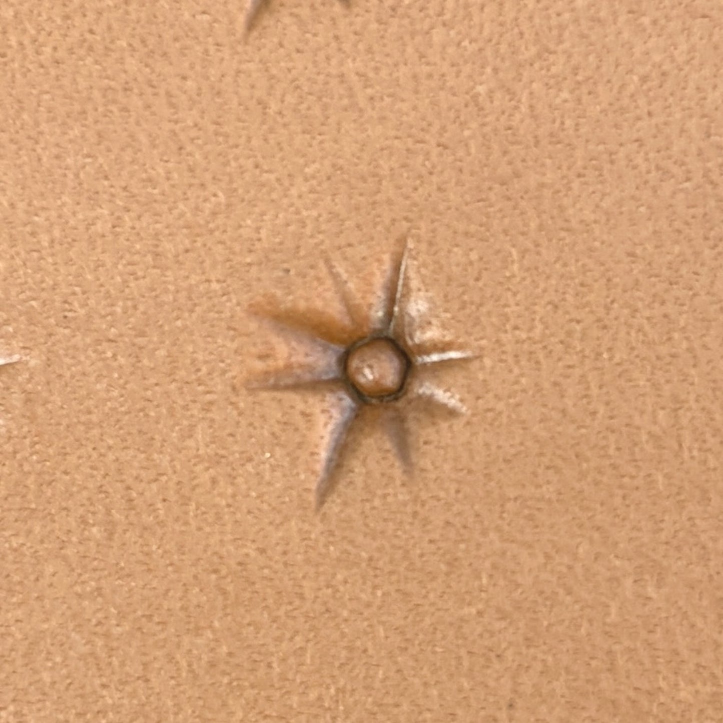 Starburst leather stamp LT743 — single impression on veg-tan leather
