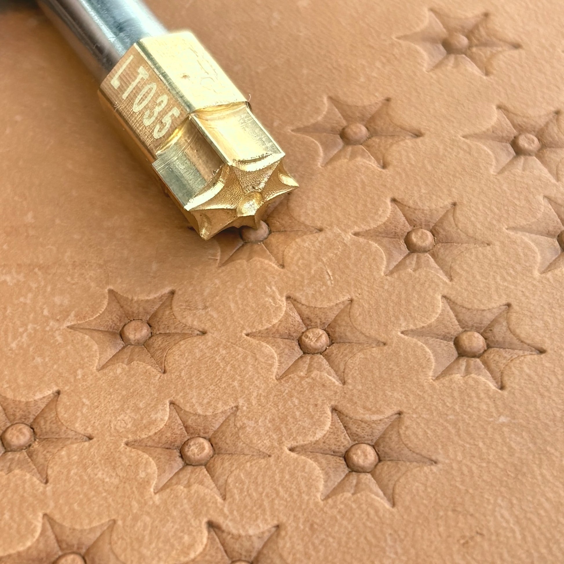 Starburst leather stamp LT035 — brass stamping tool with imprint on natural veg-tan leather