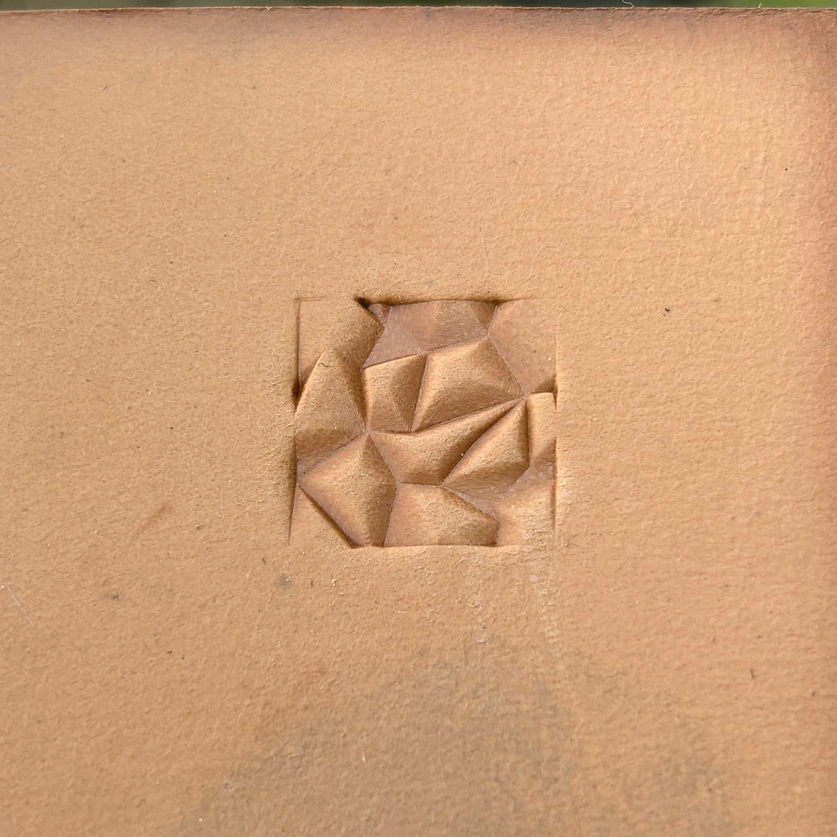 Origami Style Geometric leather stamp LT051 — single impression on veg-tan leather