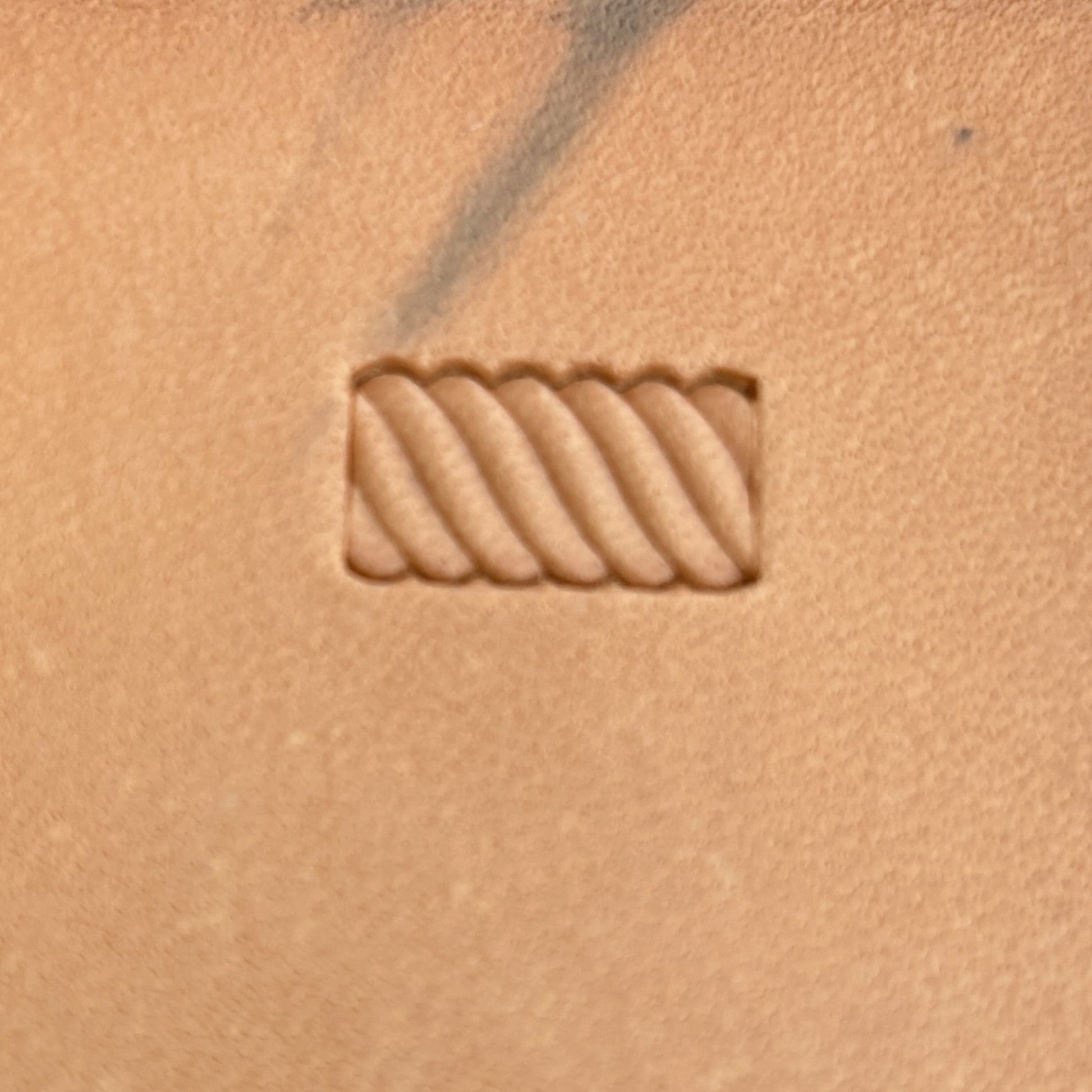 Stitches leather stamp LT057 — single impression on veg-tan leather
