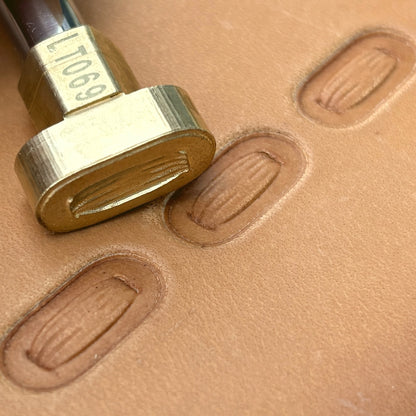 Oval Stitches leather stamp LT069 — brass stamping tool with imprint on natural veg-tan leather