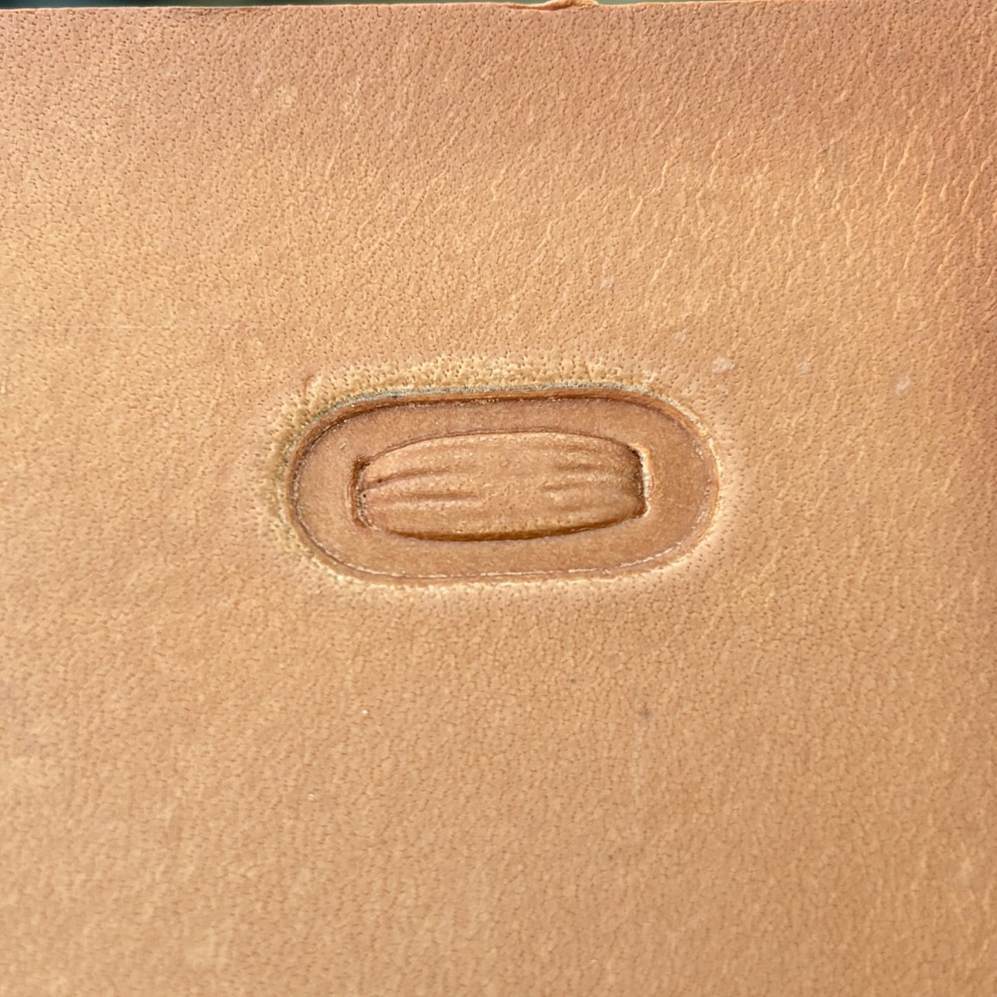 Oval Stitches leather stamp LT069 — single impression on veg-tan leather