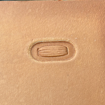 Oval Stitches leather stamp LT069 — single impression on veg-tan leather