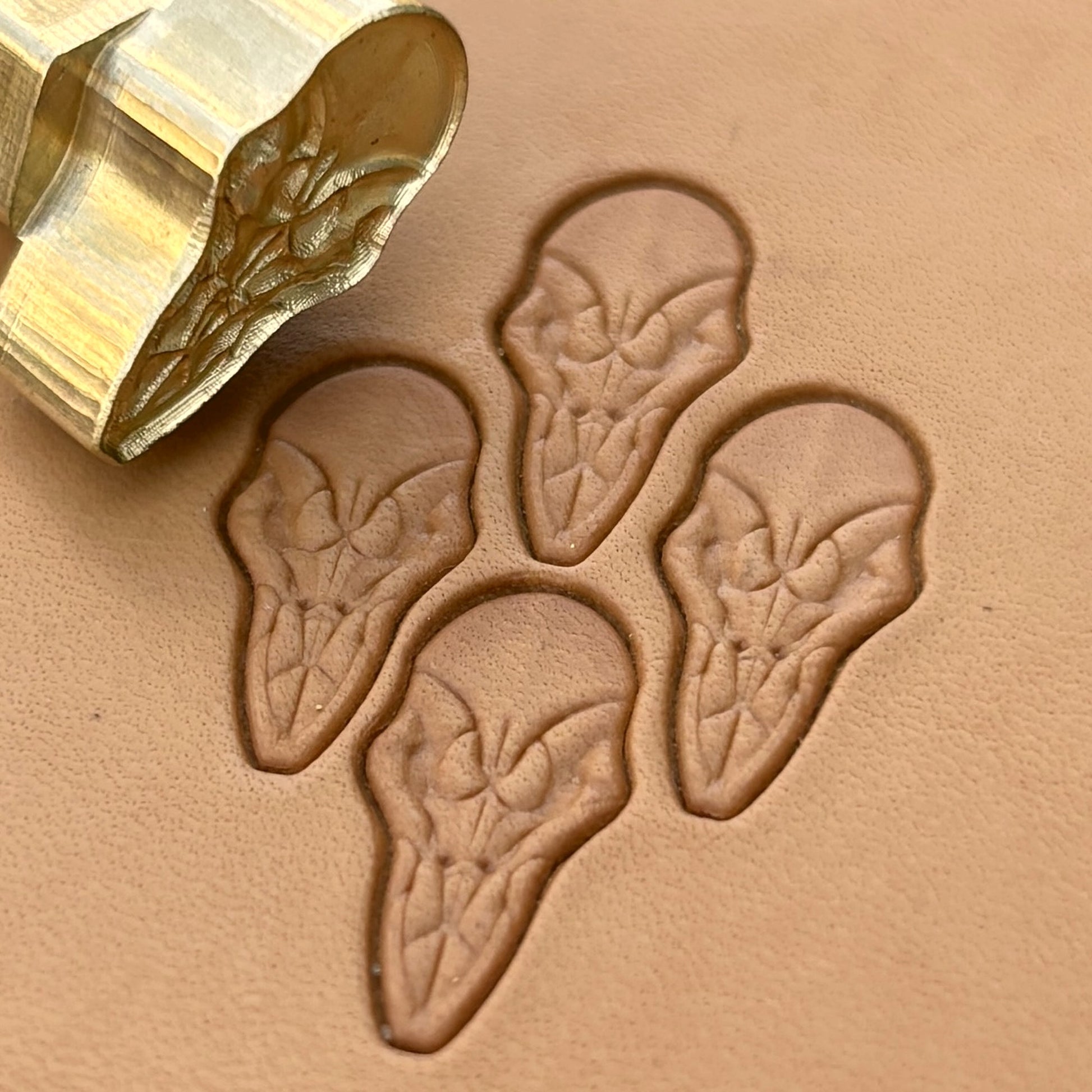 Alien Skull leather stamp LT077 — brass stamping tool with imprint on natural veg-tan leather