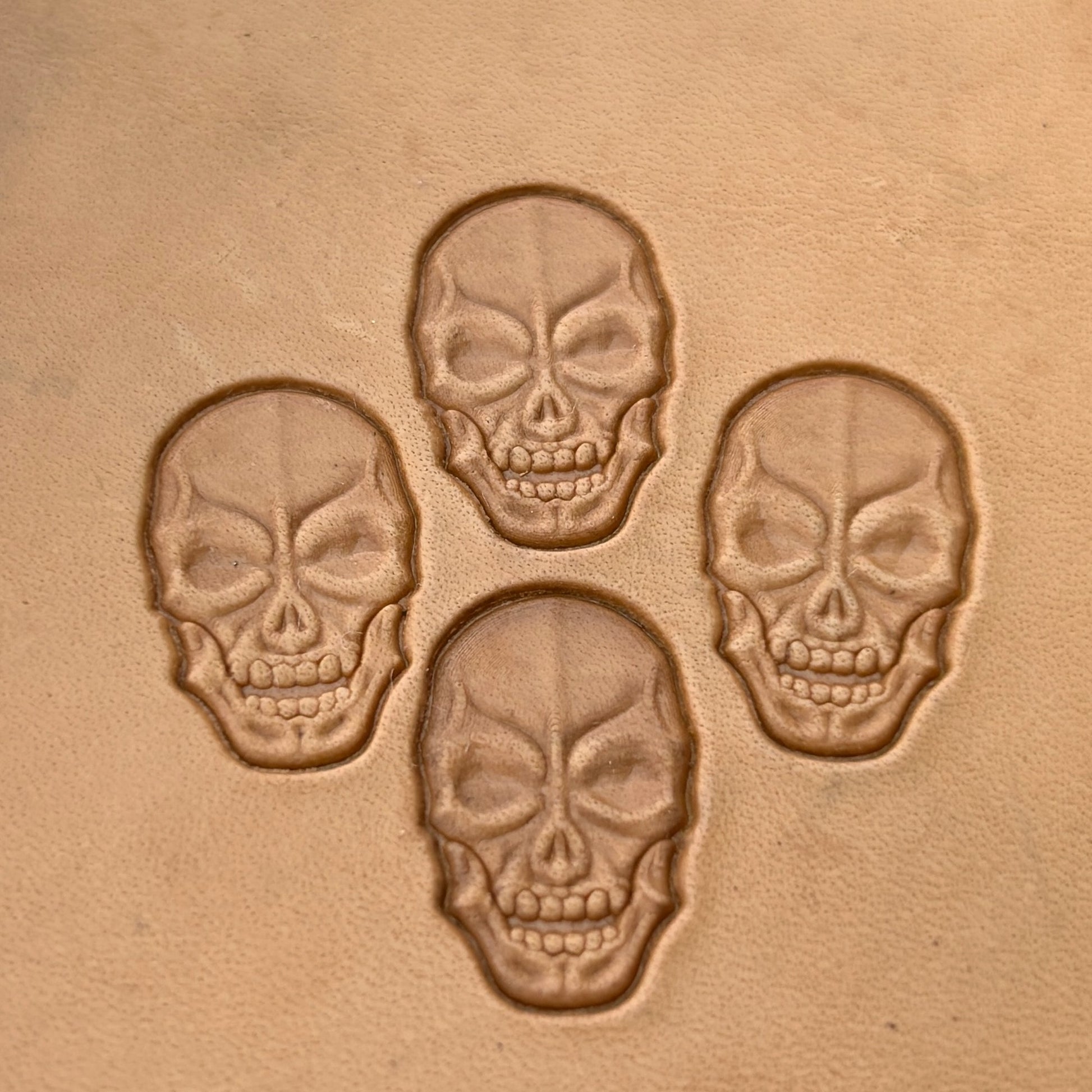 Grim Face Skull leather stamp LT080 — single impression on veg-tan leather