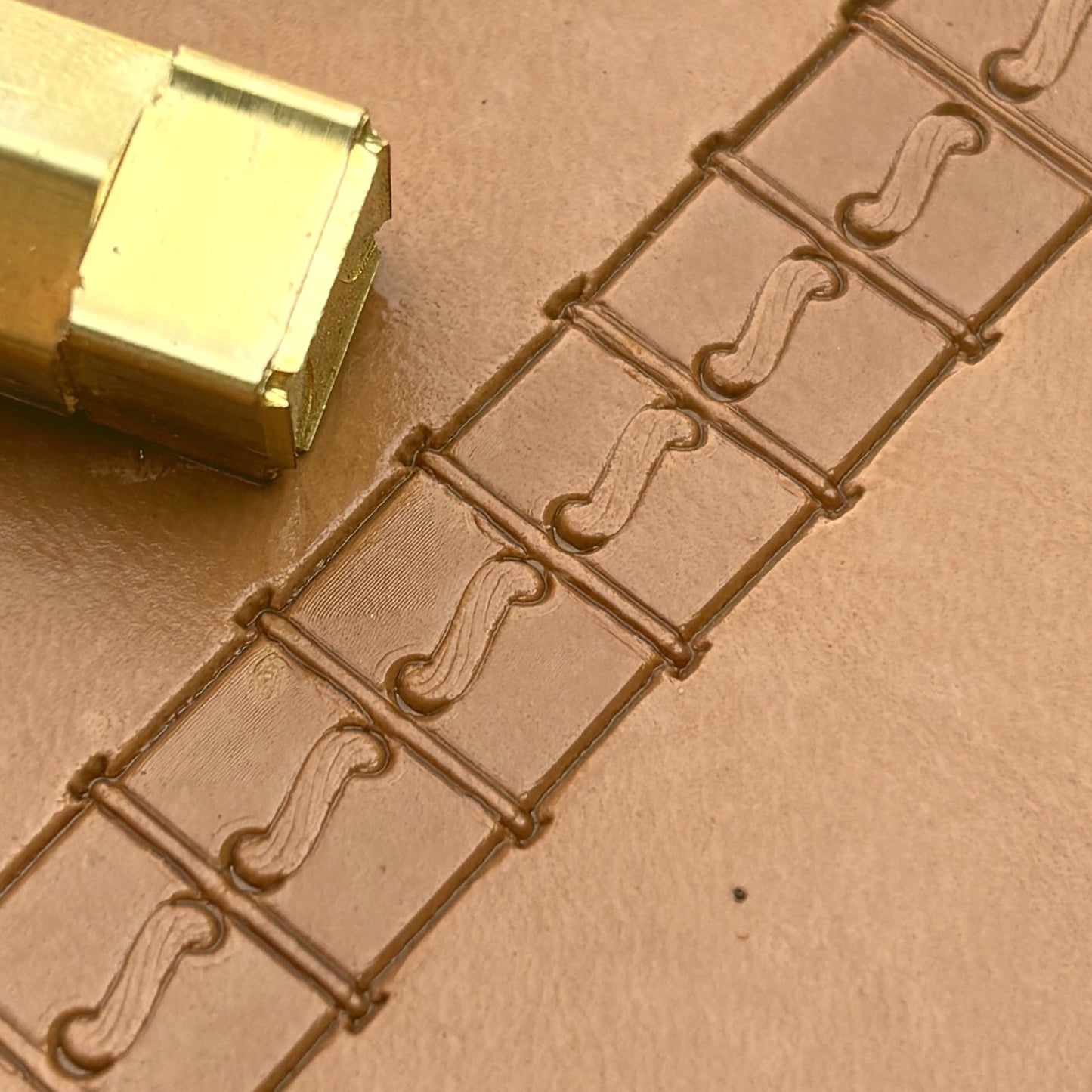 Boxed Line Stitches leather stamp LT087 — brass stamping tool with imprint on natural veg-tan leather