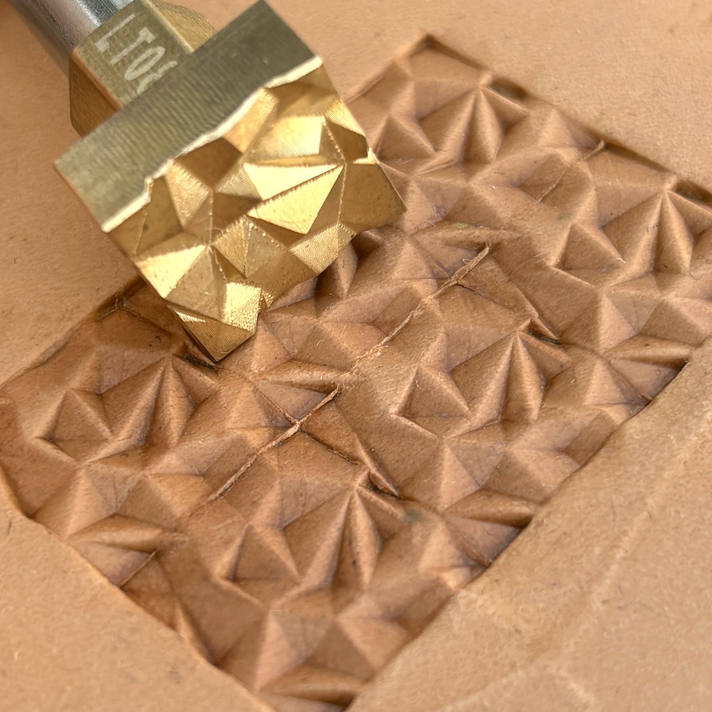 Geometric leather stamp LT089 — brass stamping tool with imprint on natural veg-tan leather