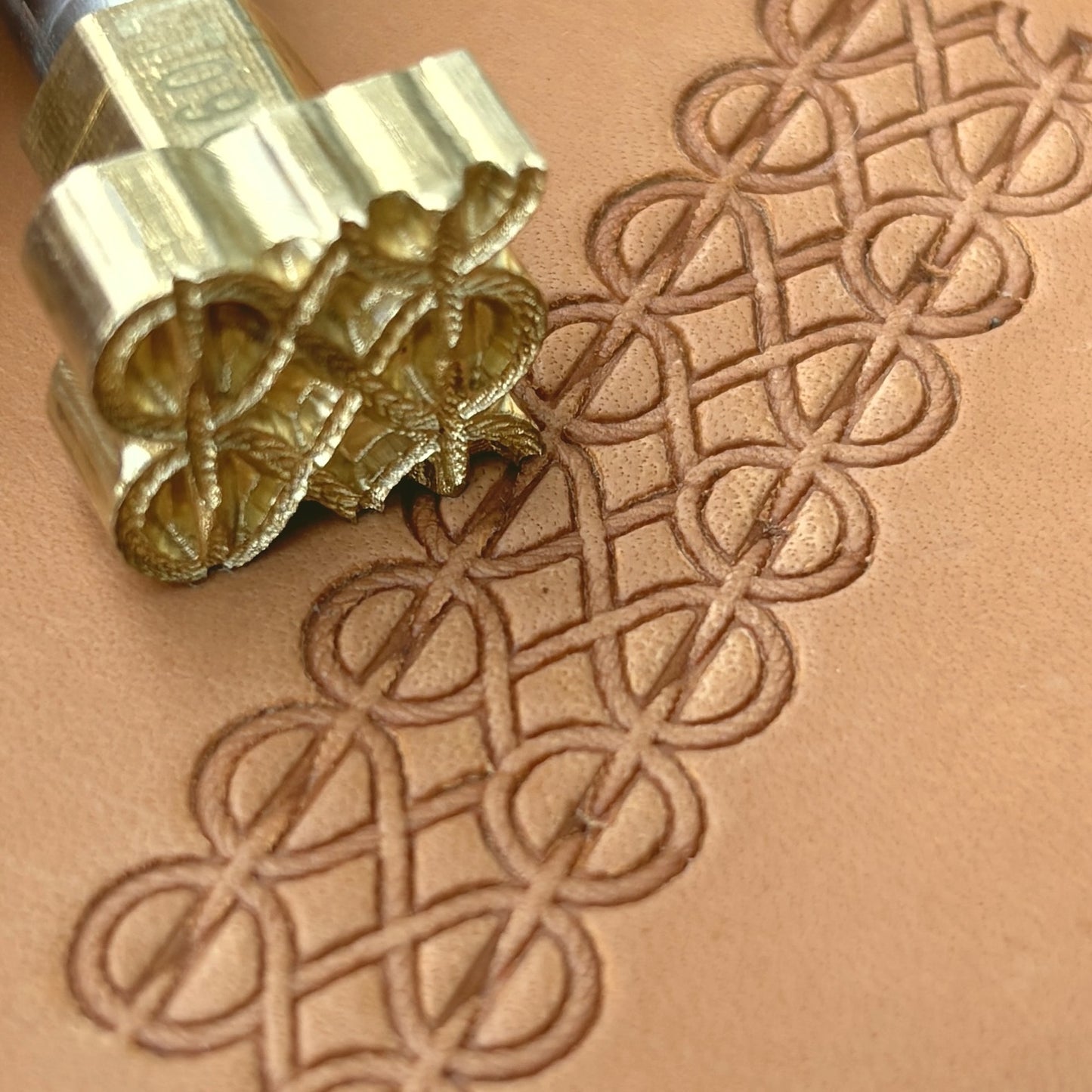 Interlocking Lines leather stamp LT090 — brass stamping tool with imprint on natural veg-tan leather