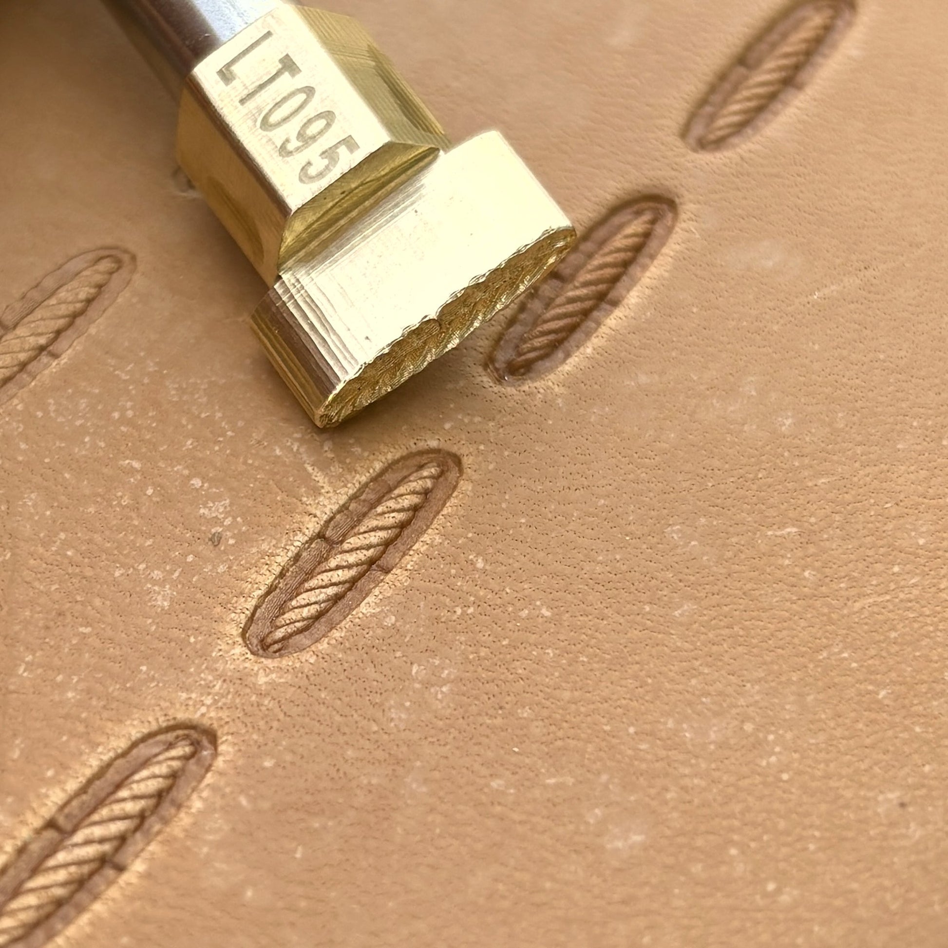 Oval Style Stitches leather stamp LT095 — brass stamping tool with imprint on natural veg-tan leather