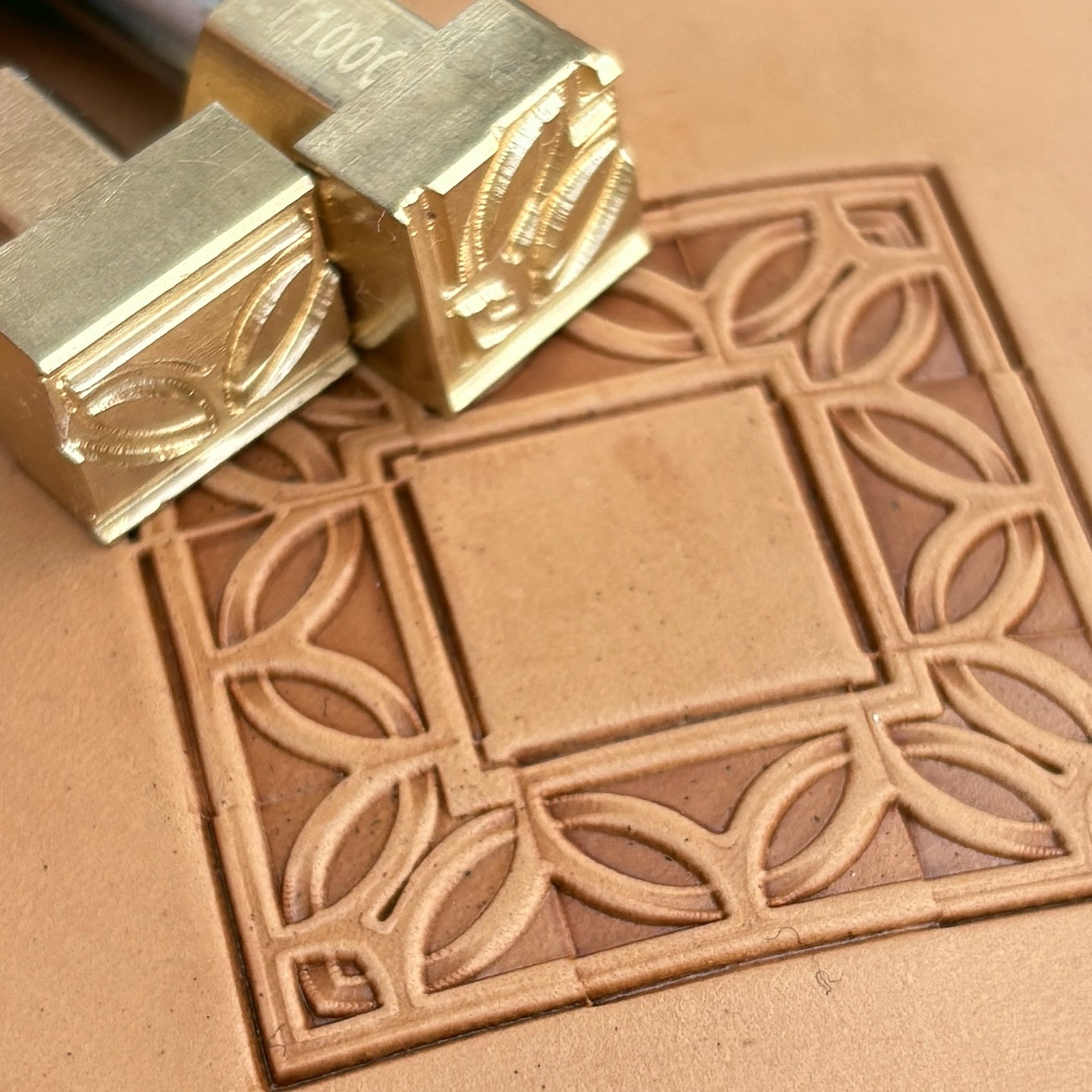 Geometric leather stamp LT100 — brass stamping tool with imprint on natural veg-tan leather