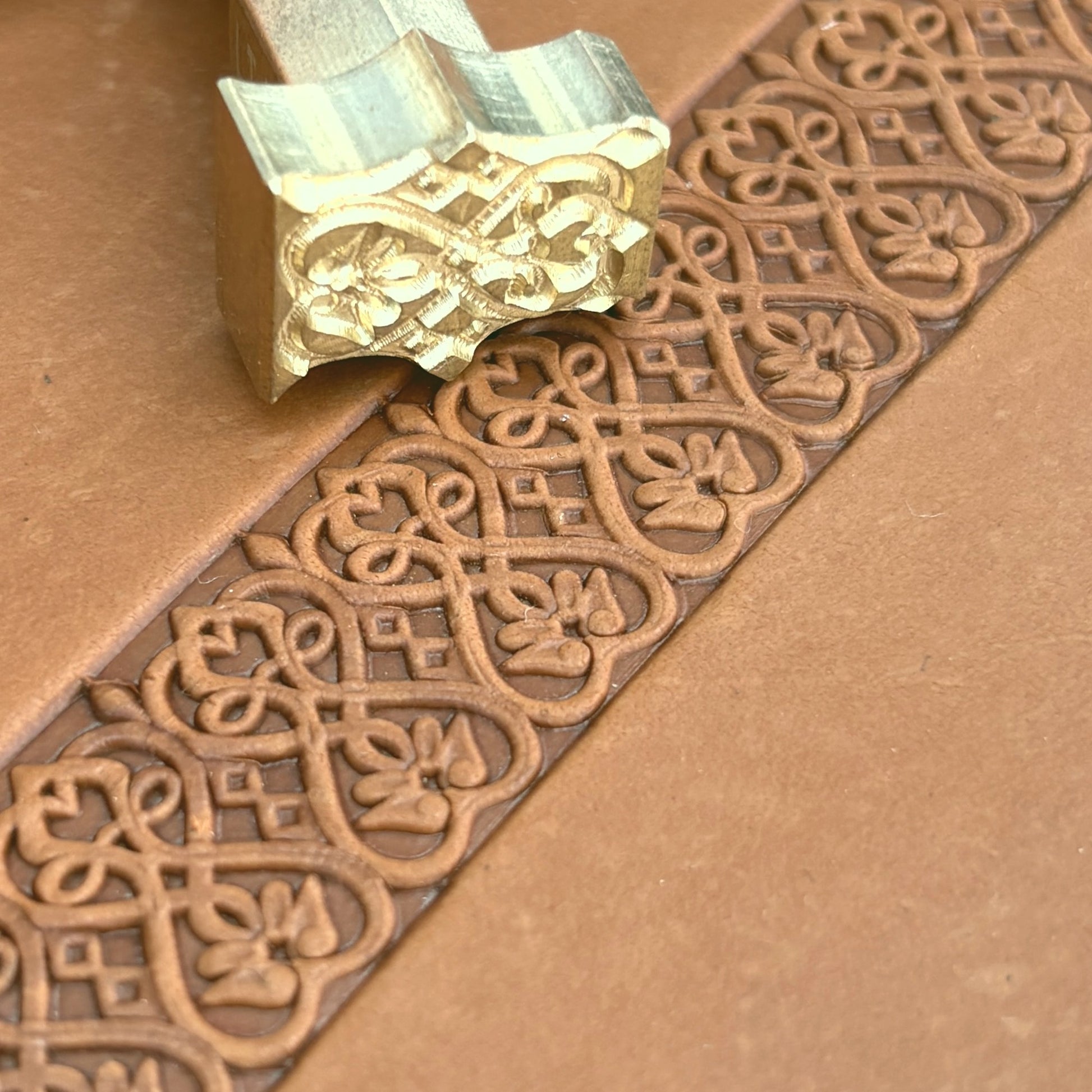 Floral Loop leather stamp LT108 — brass stamping tool with imprint on natural veg-tan leather