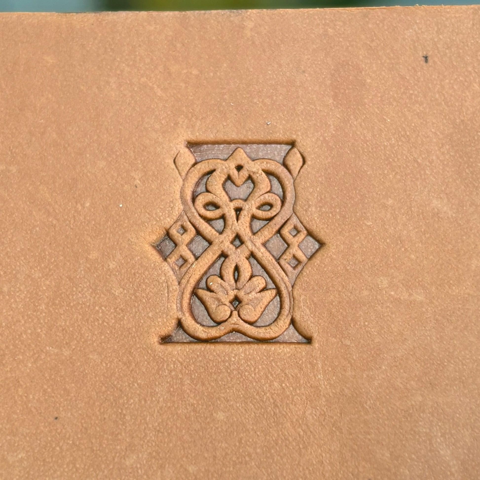 Floral Loop leather stamp LT108 — single impression on veg-tan leather