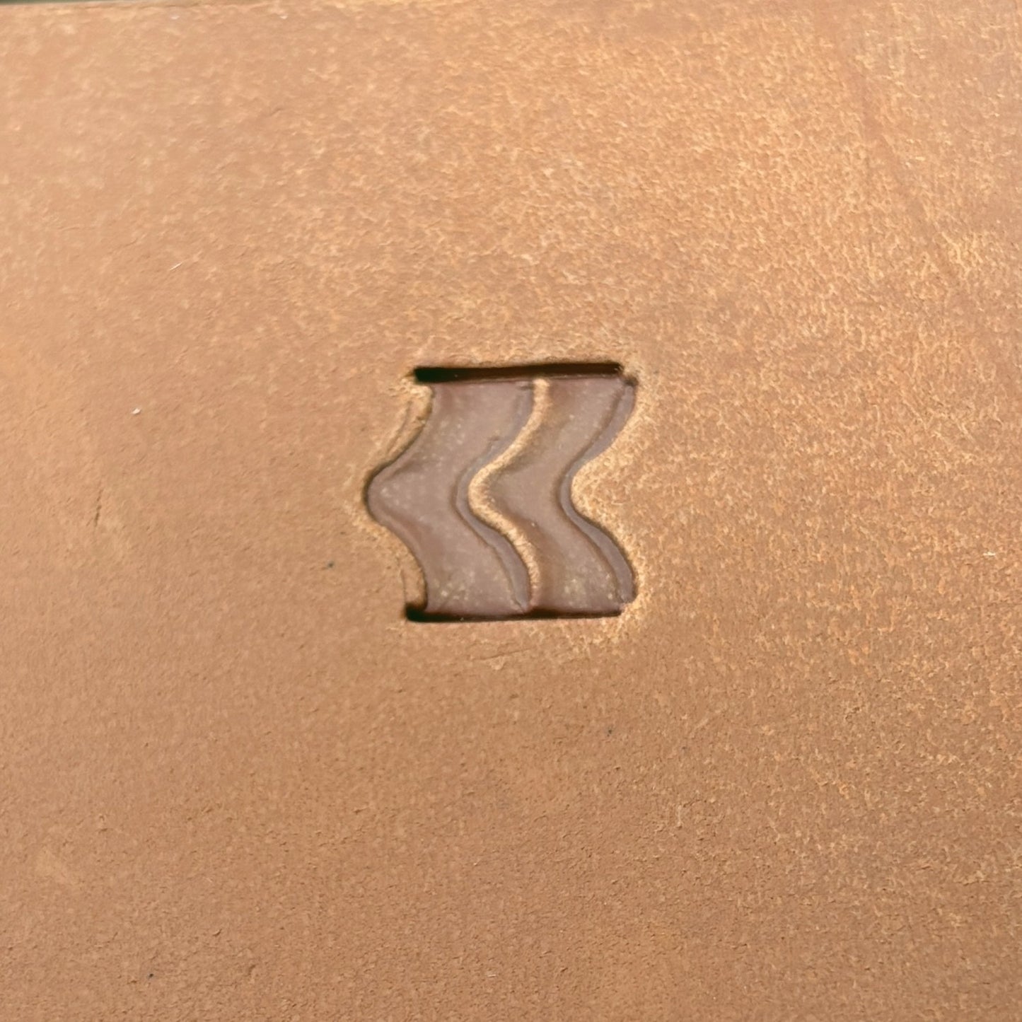 Wavy Line leather stamp LT116 — single impression on veg-tan leather