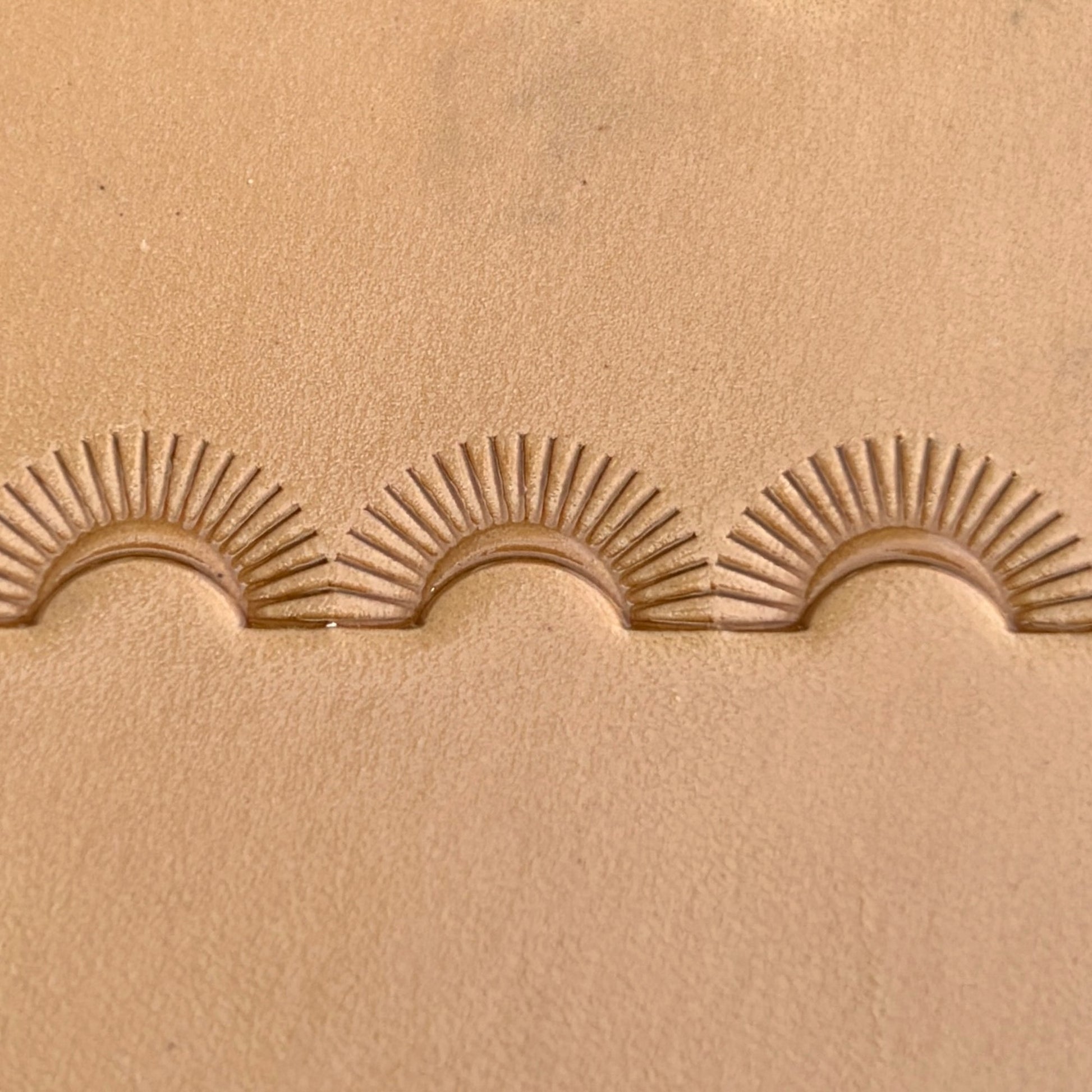 Sunburst Border leather stamp LT124 — single impression on veg-tan leather
