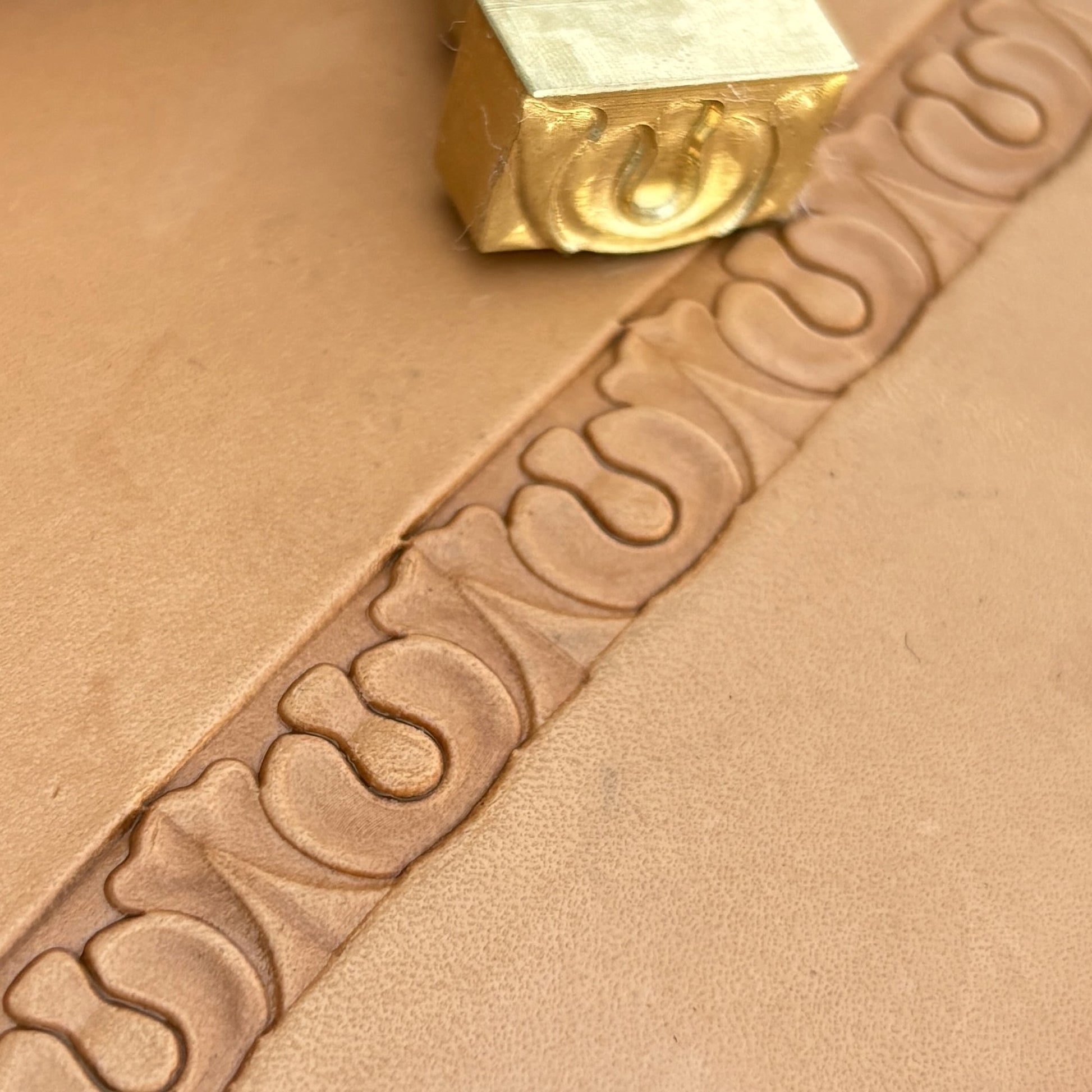 Ornate leather stamp LT129 — brass stamping tool with imprint on natural veg-tan leather