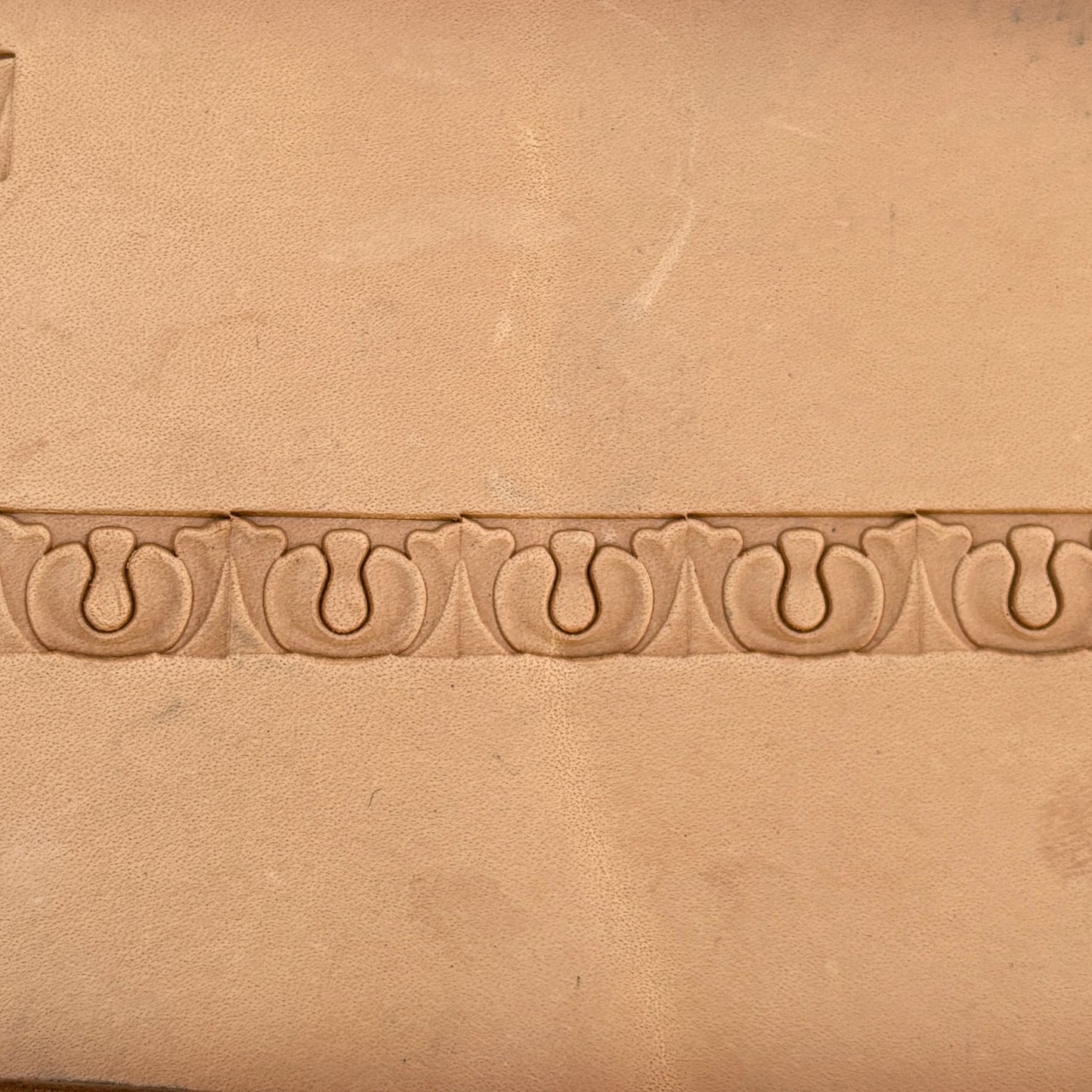 Ornate leather stamp LT129 — single impression on veg-tan leather