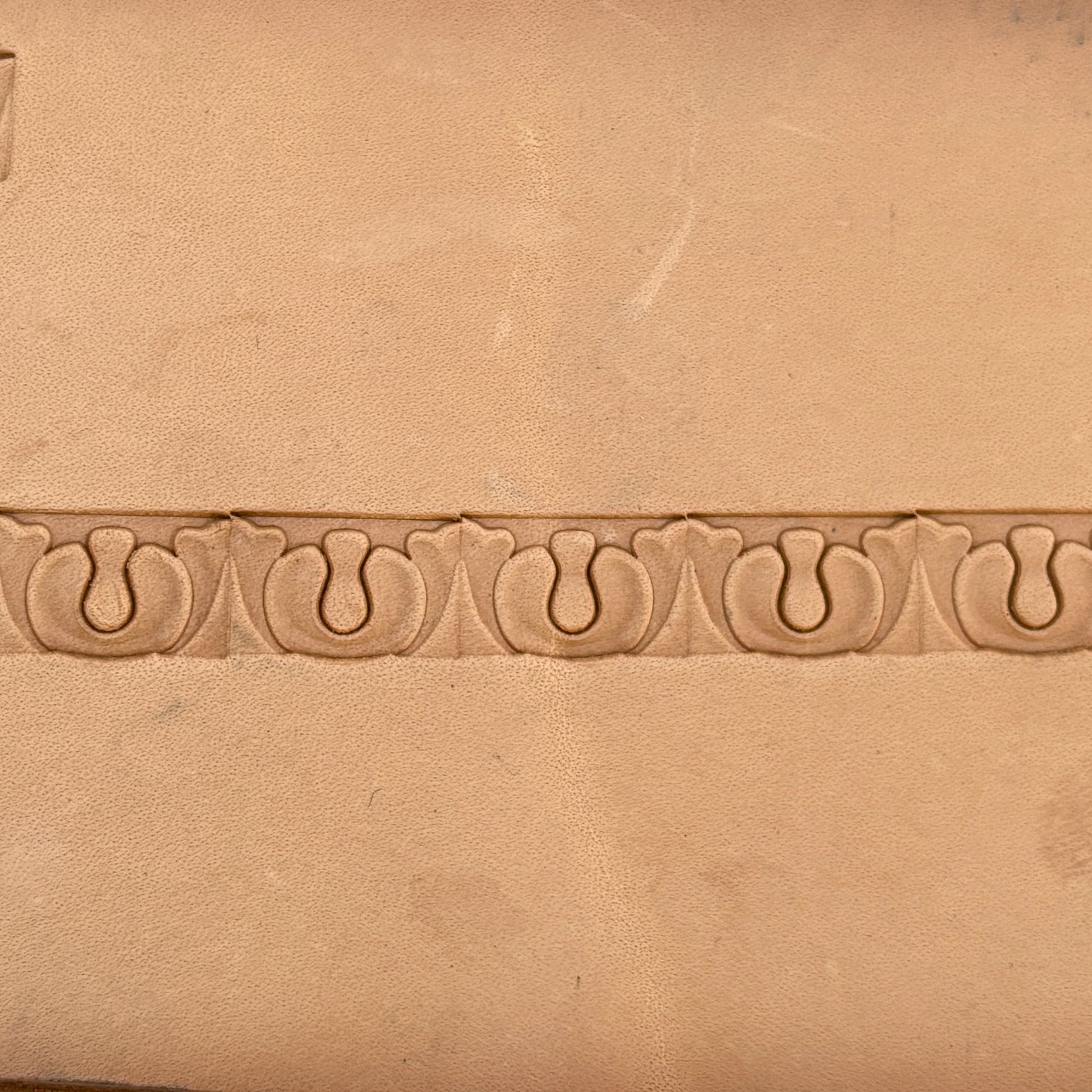 Ornate leather stamp LT129 — single impression on veg-tan leather