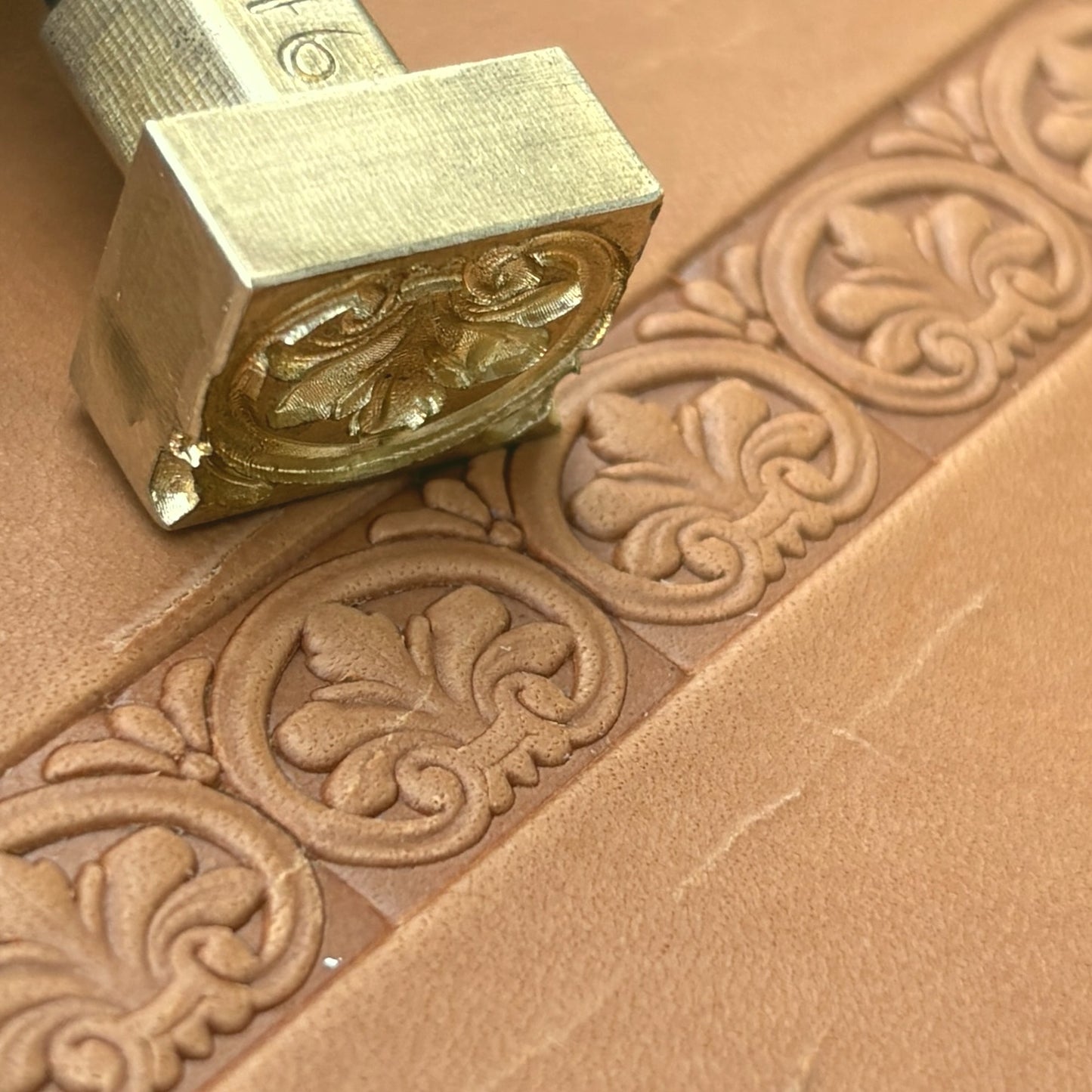 Ornate leather stamp LT146 — brass stamping tool with imprint on natural veg-tan leather