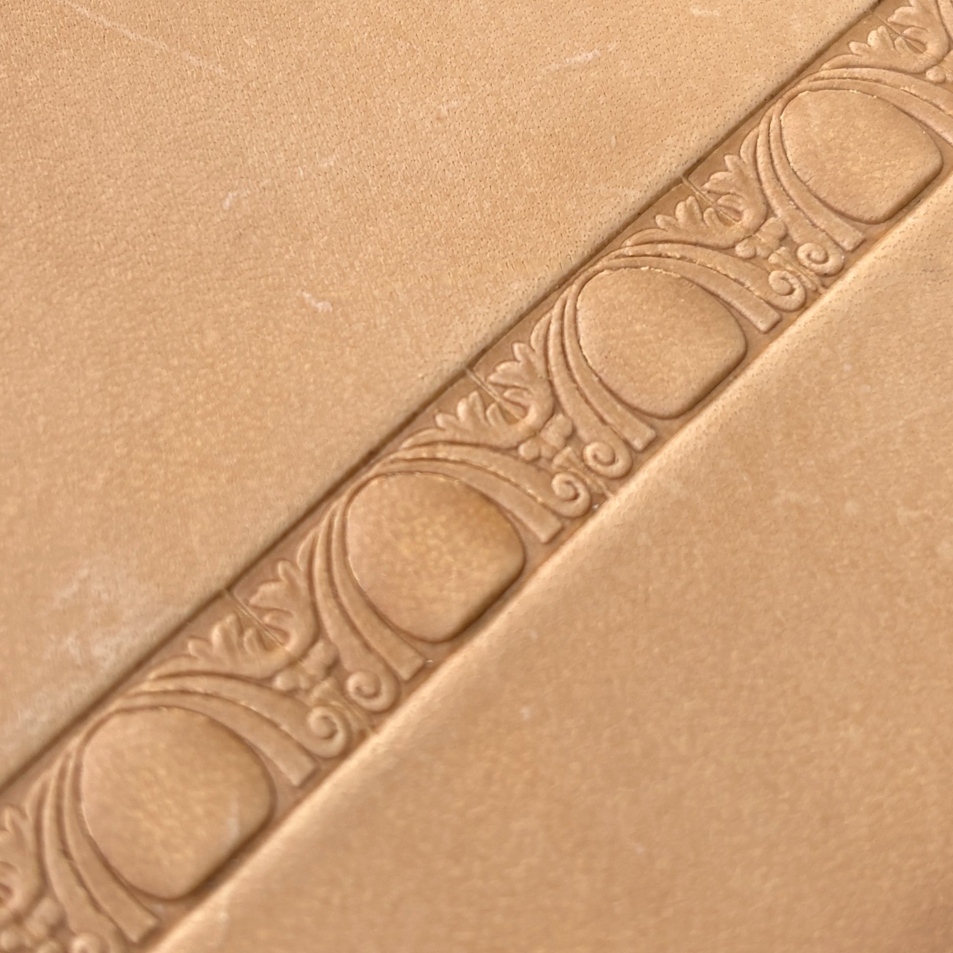 Art Deco leather stamp LT150 — single impression on veg-tan leather