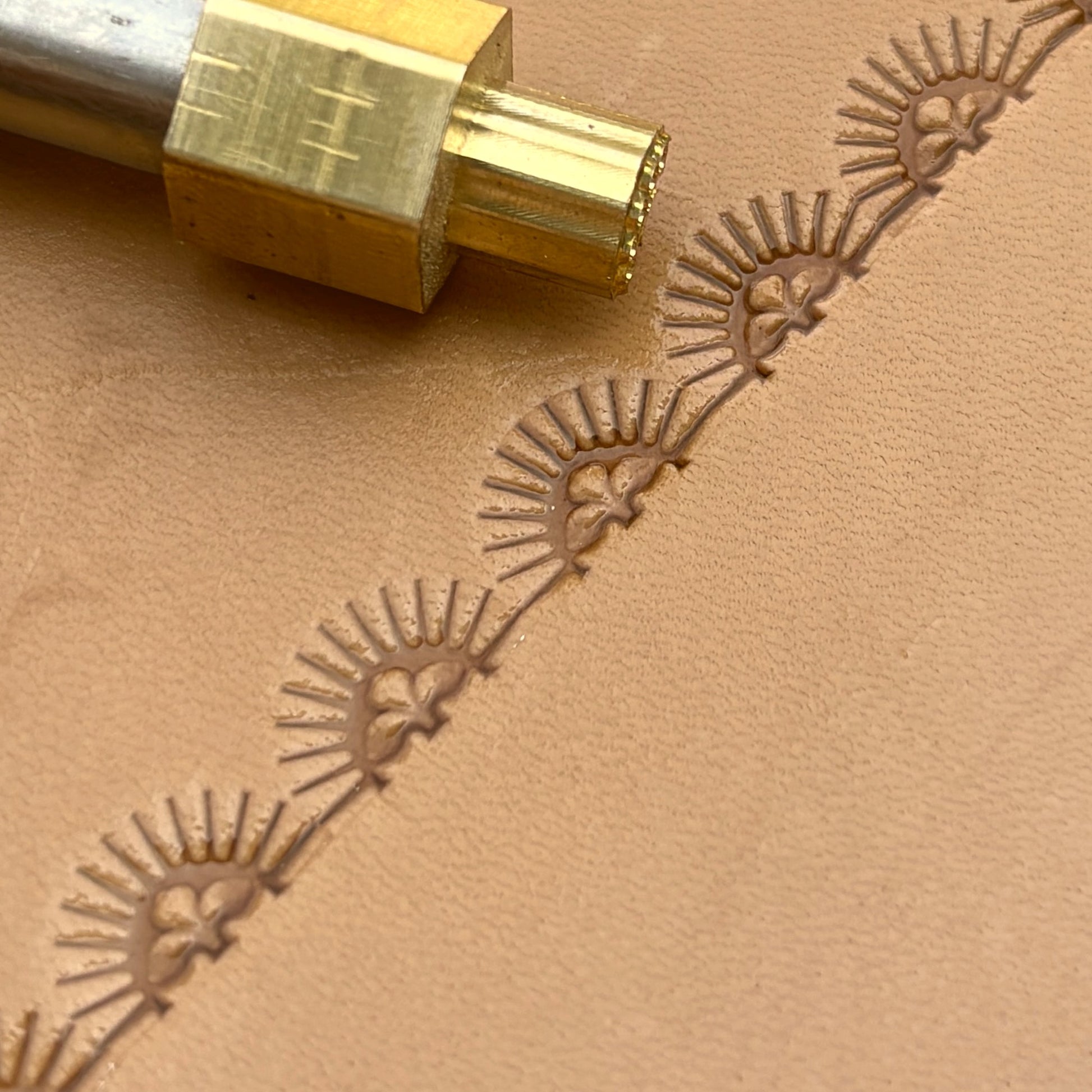 Sunburst Border leather stamp LT164 — brass stamping tool with imprint on natural veg-tan leather