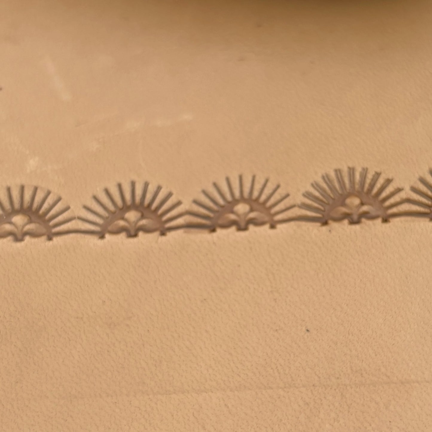 Sunburst Border leather stamp LT164 — pattern imprint on veg-tan leather