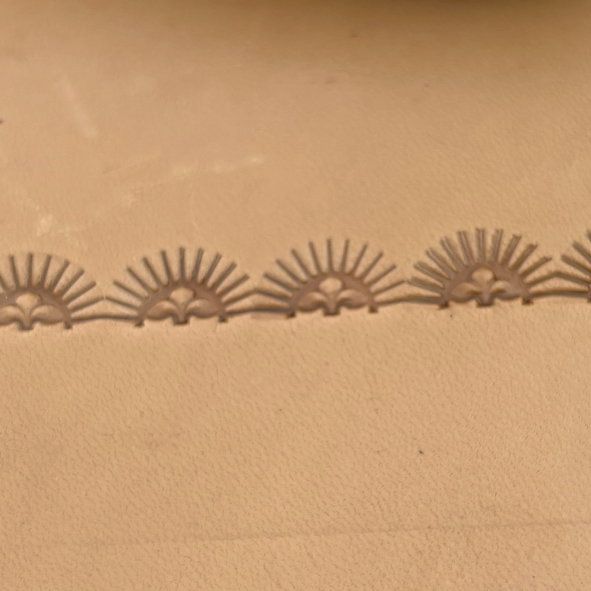 Sunburst Border leather stamp LT164 — pattern imprint on veg-tan leather