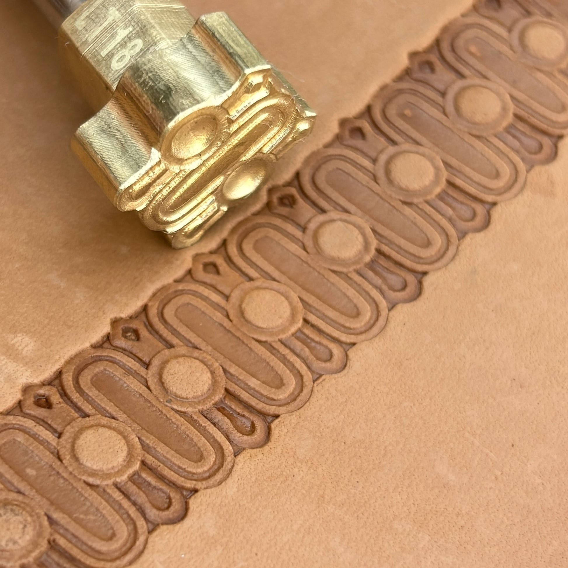 Oval Border leather stamp LT183 — brass stamping tool with imprint on natural veg-tan leather