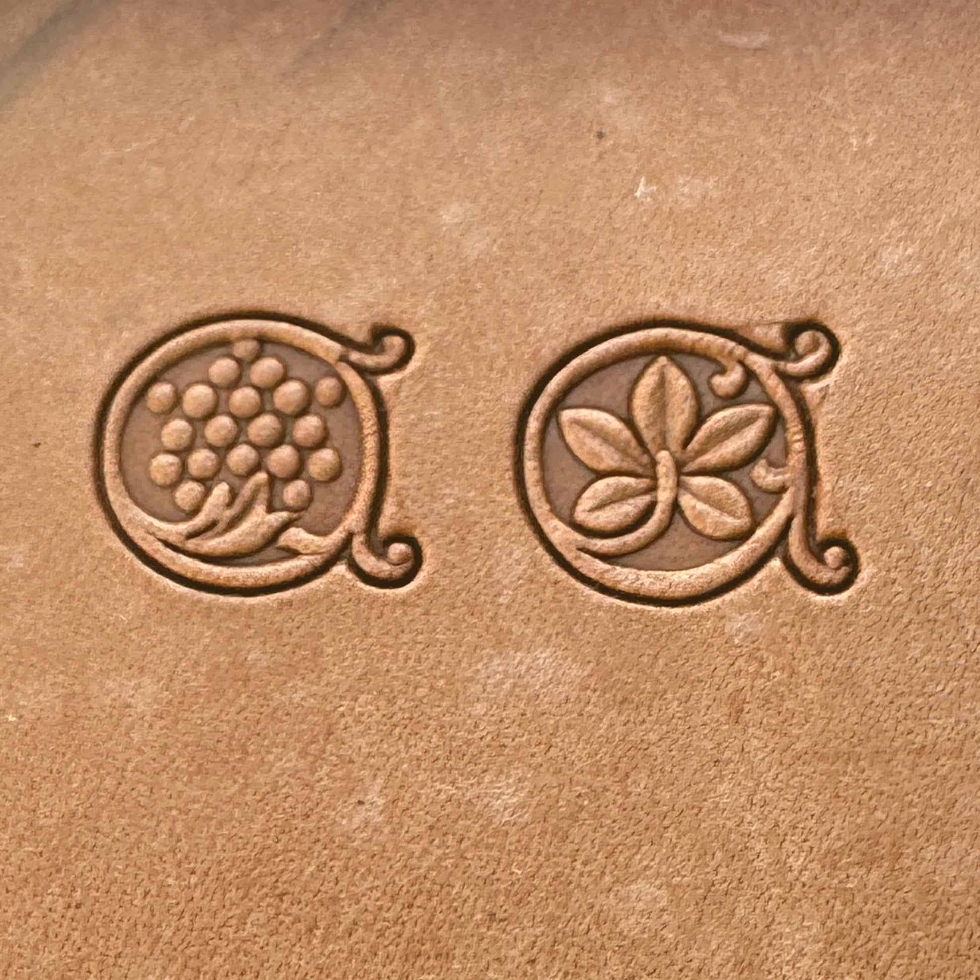 Grape Vine leather stamp LT184AB — single impressions of the grape cluster and vine leaf stamps on veg-tan leather