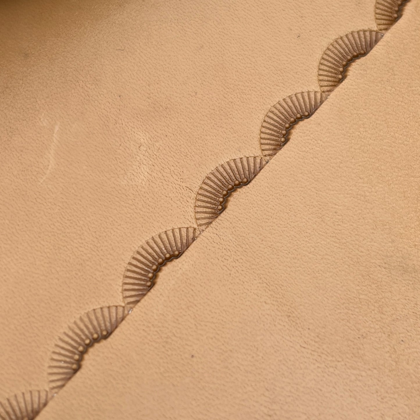 Radiant Curve Stitches leather stamp LT197 — pattern imprint on veg-tan leather