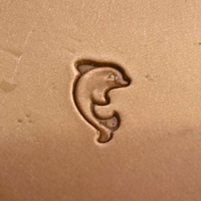Dolphin leather stamp LT201 — single impression on veg-tan leather