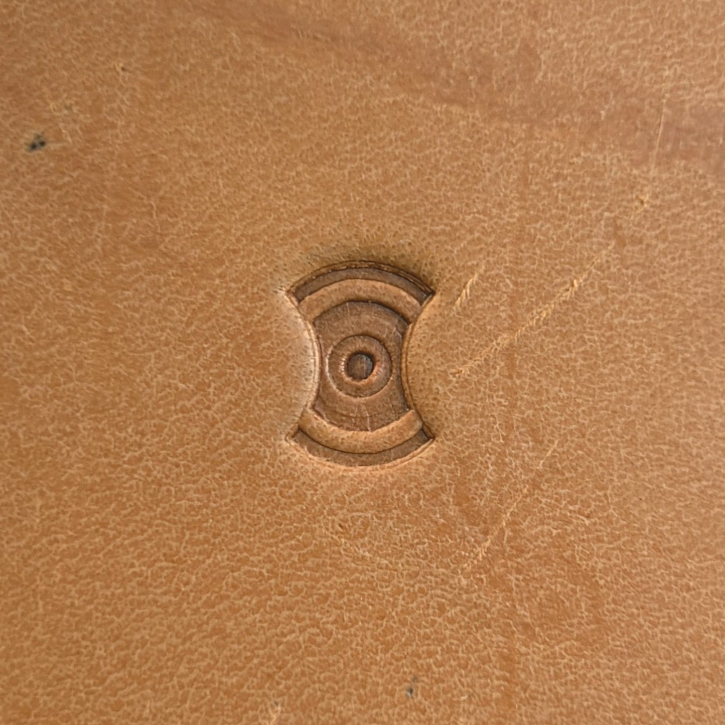 Concentric Cross Geometric leather stamp LT202 — single impression on veg-tan leather
