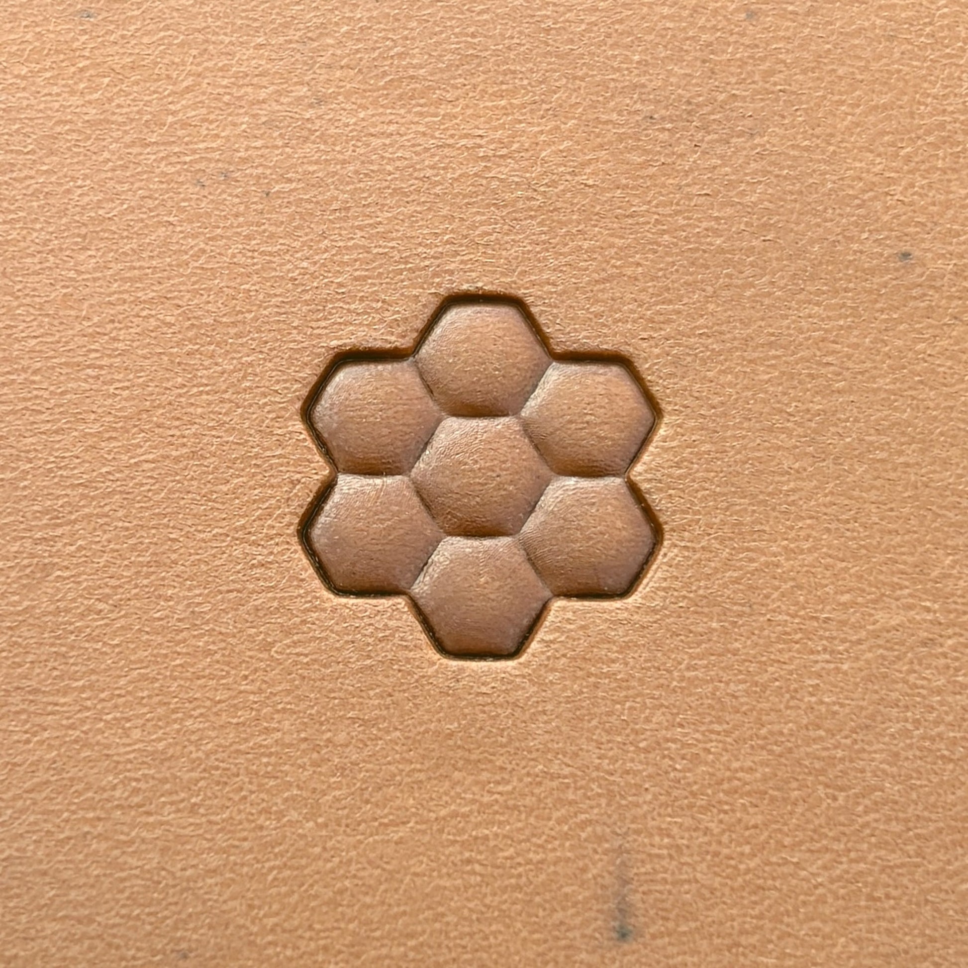 Honeycomb Bee leather stamp LT212 — single impression on veg-tan leather