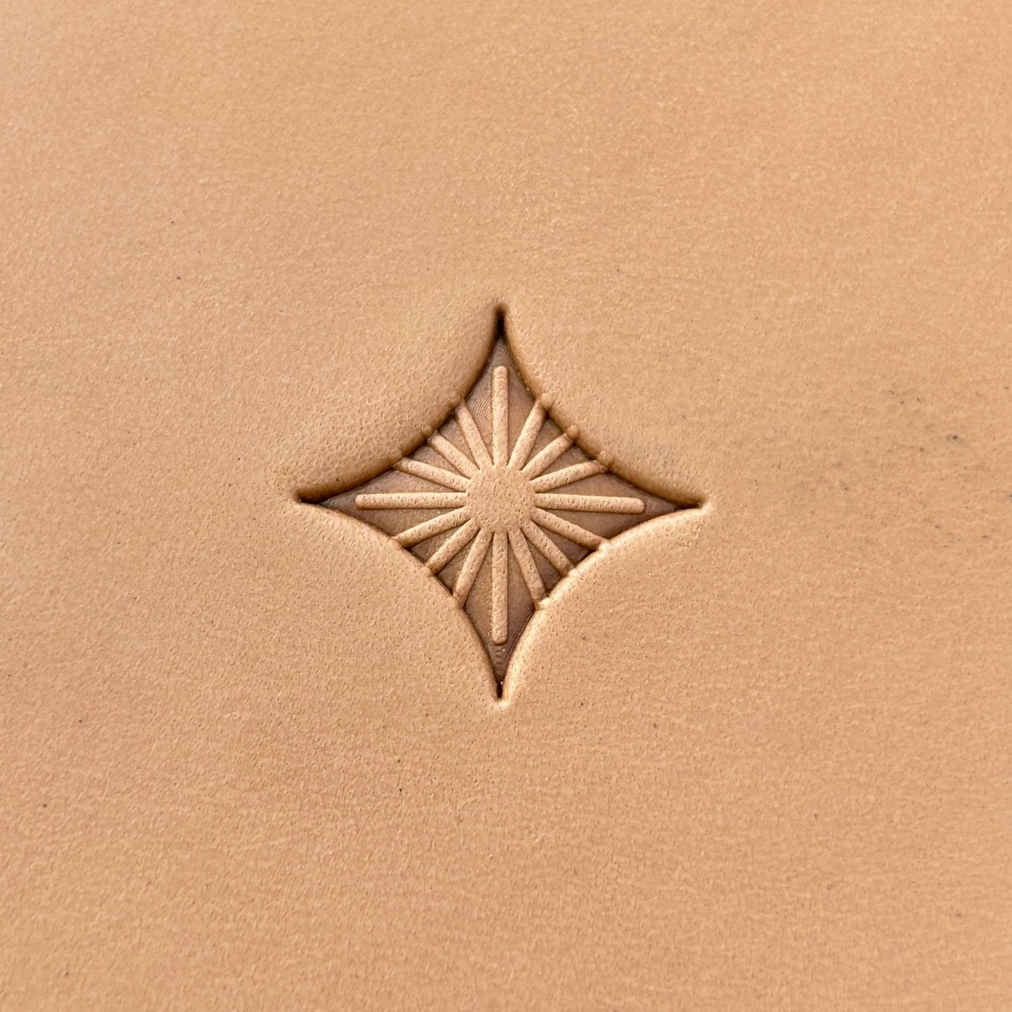 Starburst Geometric leather stamp LT223 — single impression on veg-tan leather