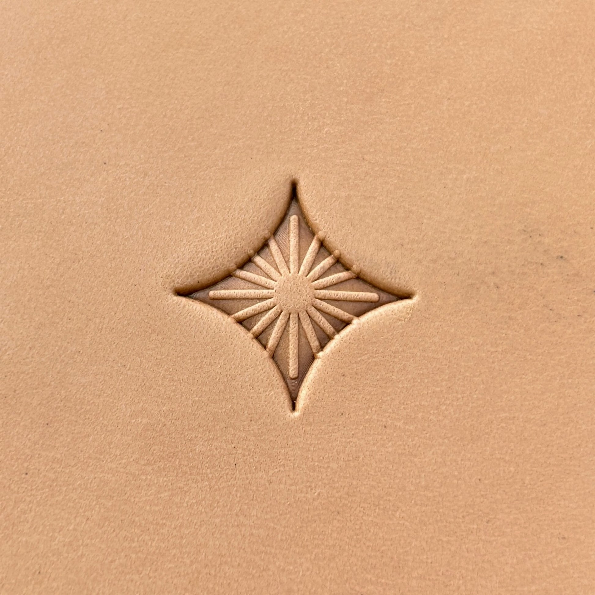 Starburst Geometric leather stamp LT223 — single impression on veg-tan leather