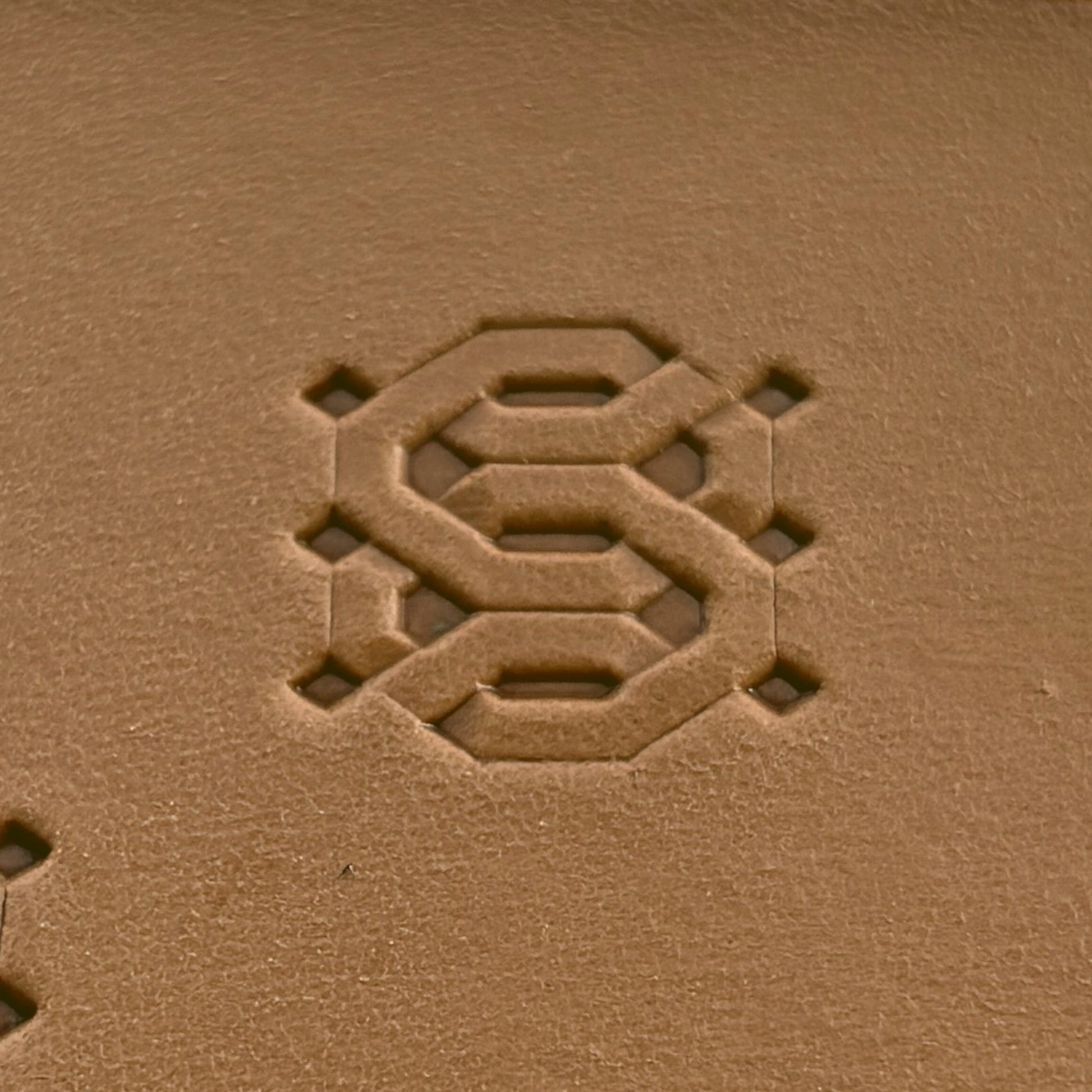 Geometric leather stamp LT258 — single impression on veg-tan leather
