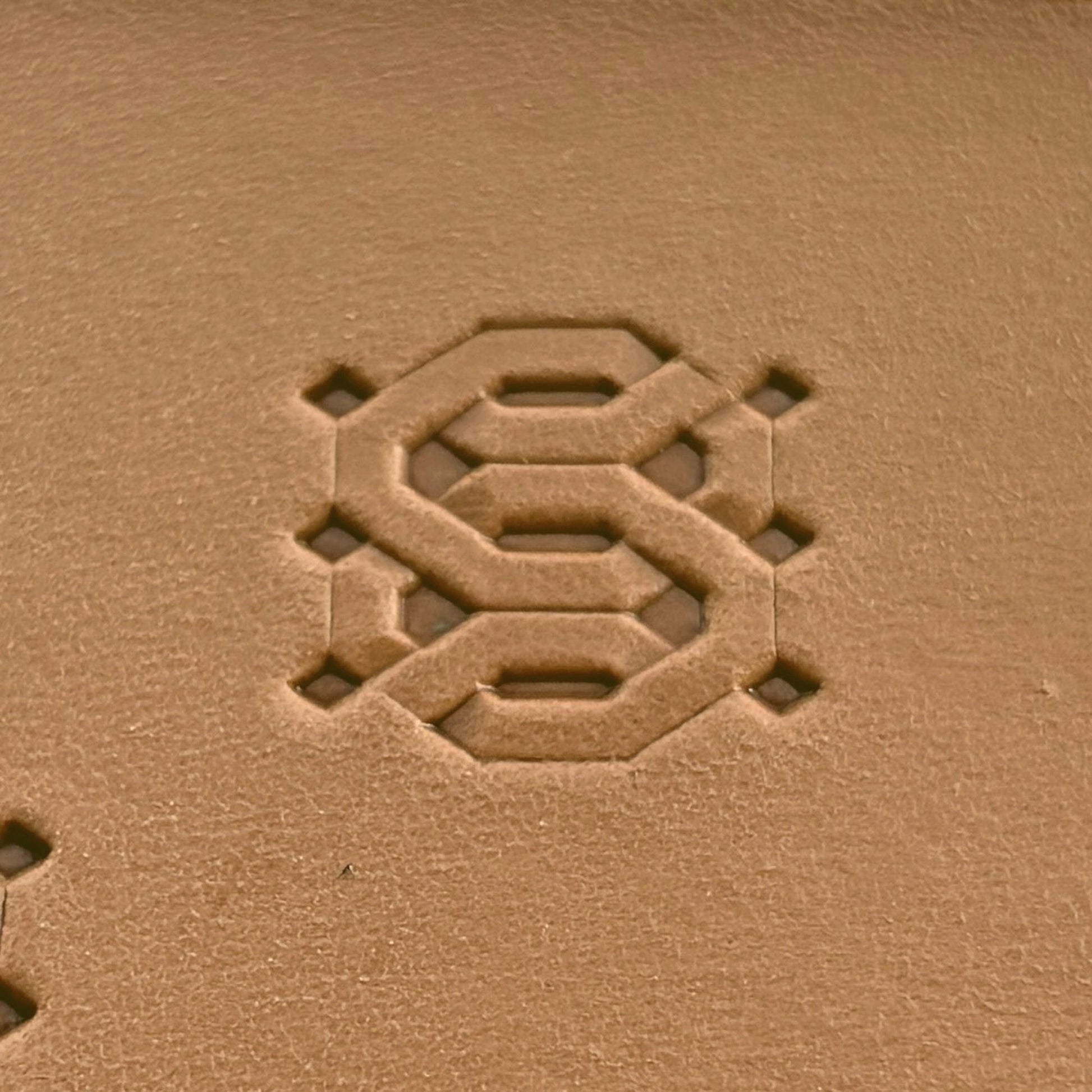 Geometric leather stamp LT258 — single impression on veg-tan leather