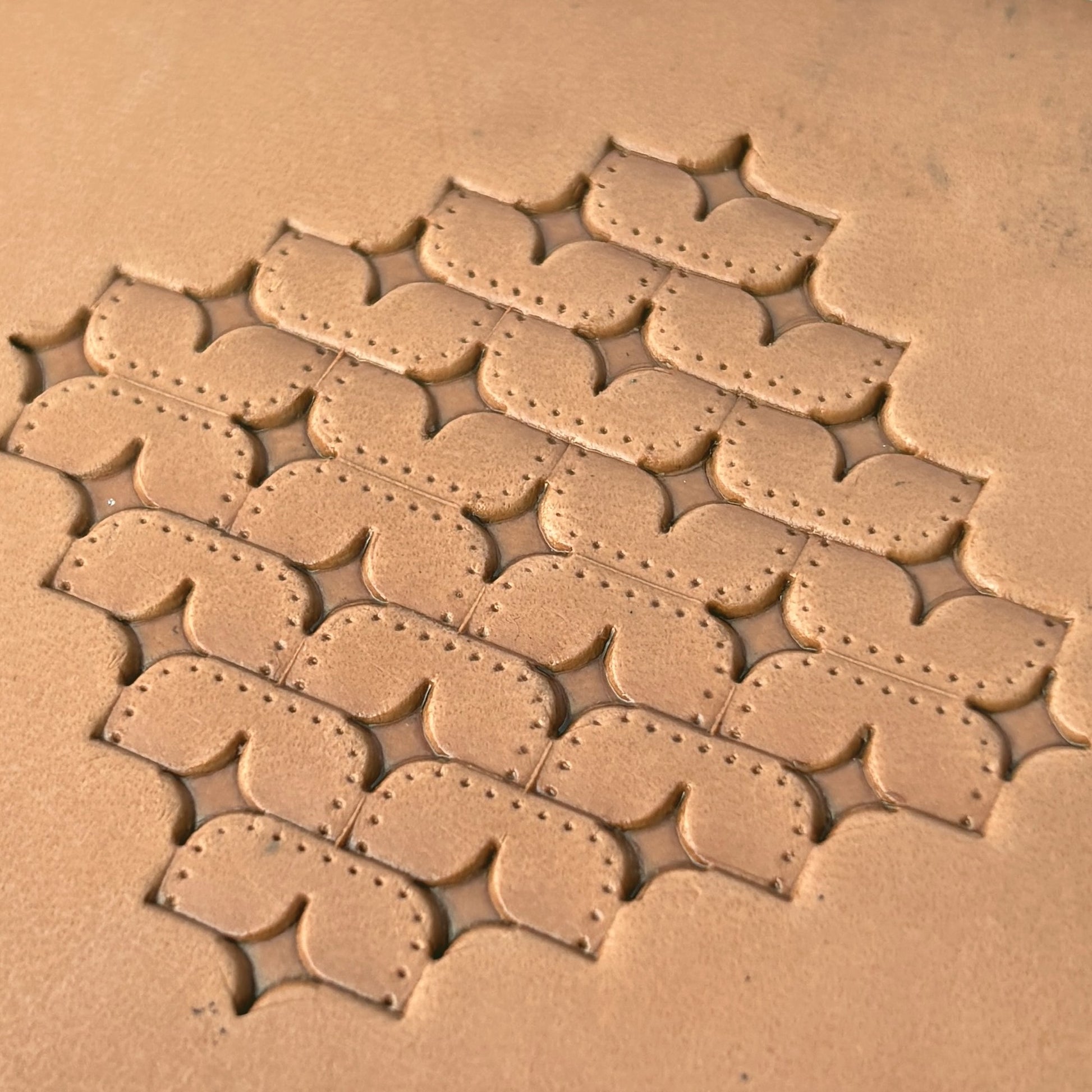 Star Tiles leather stamp LT273 — single impression on veg-tan leather